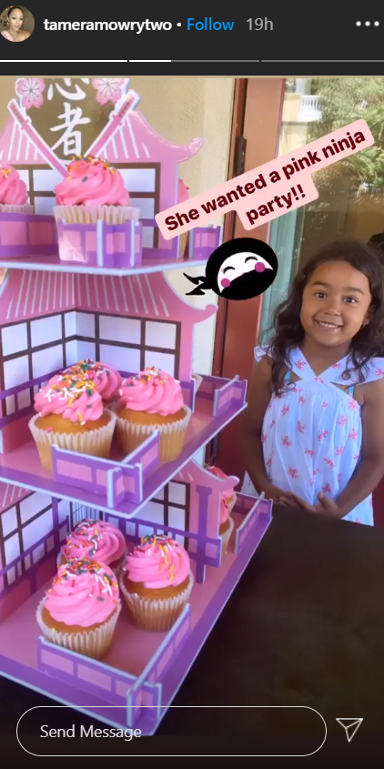 Ariah Housley standing in front of cupcakes as she celebrates her fifth birthday | Photo: Instagram/tameramowrytwo