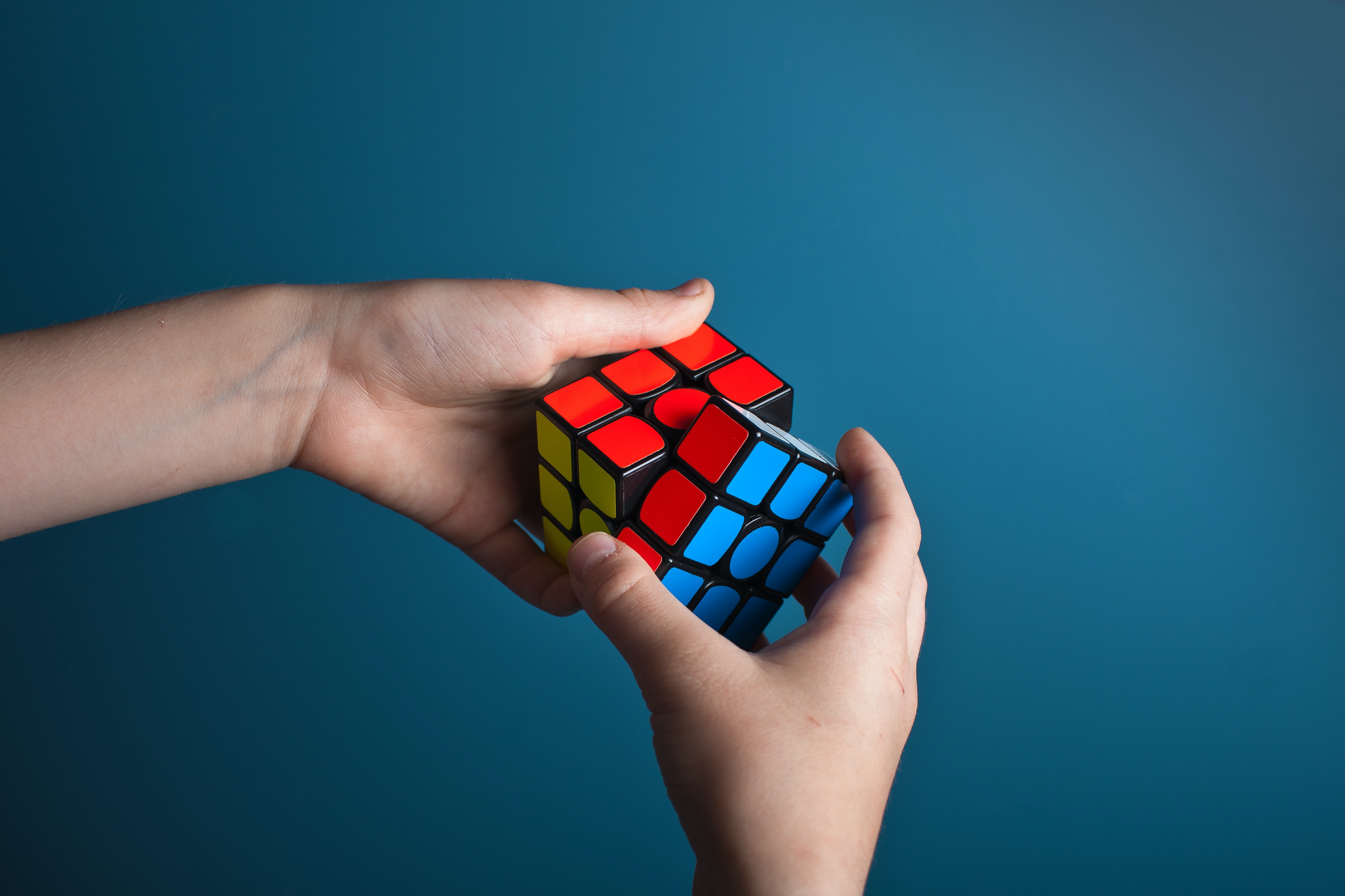 An individual solving a rubik's cube.│Source: Unsplash