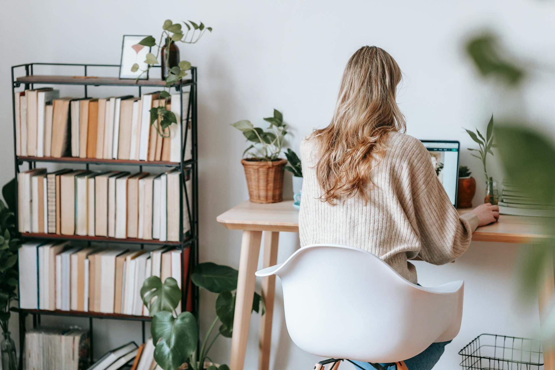 A back view of a woman using a laptop | Source: Pexels
