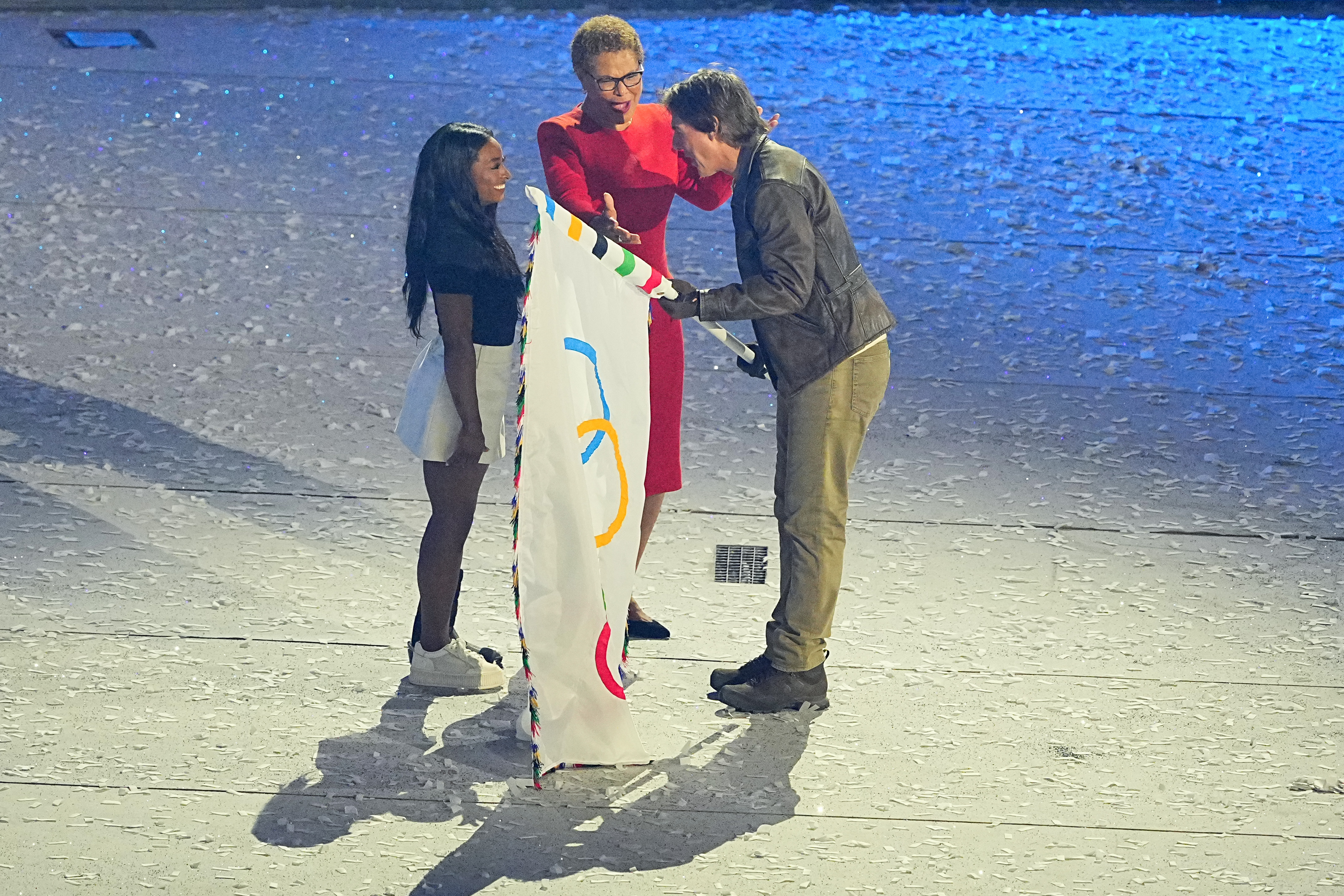 Simone Biles and Karen Bass turning over the Olympic flag to Tom Cruise on August 11, 2024 | Source: Getty Images