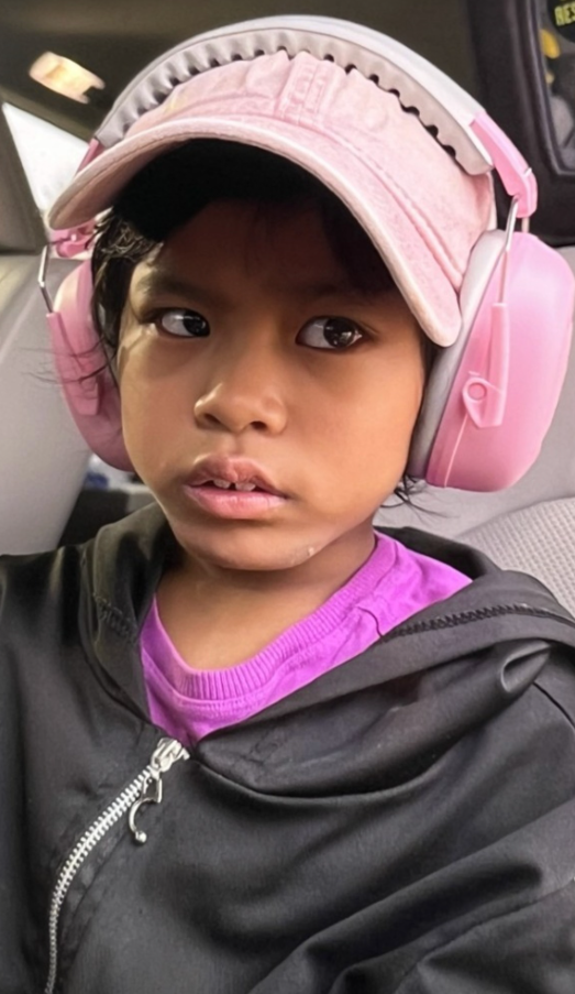 Jenny Din wearing pink headphones and a cap | Source: Facebook/bcsoky