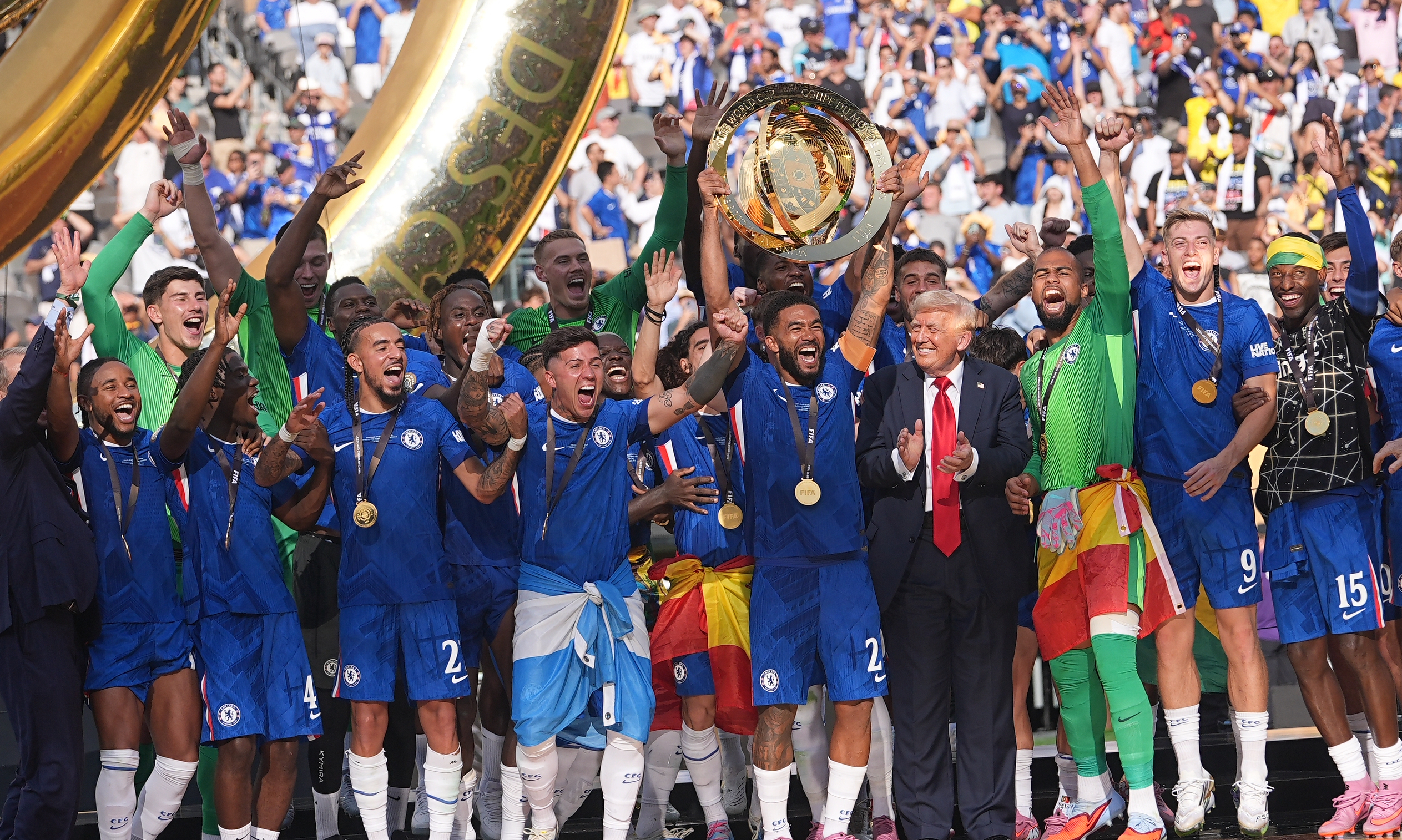 President Donald Trump while Reece James of Chelsea FC lifts the FIFA Club World Cup trophy at MetLife Stadium on July 13, 2025, in East Rutherford, New Jersey. | Source: Getty Images
