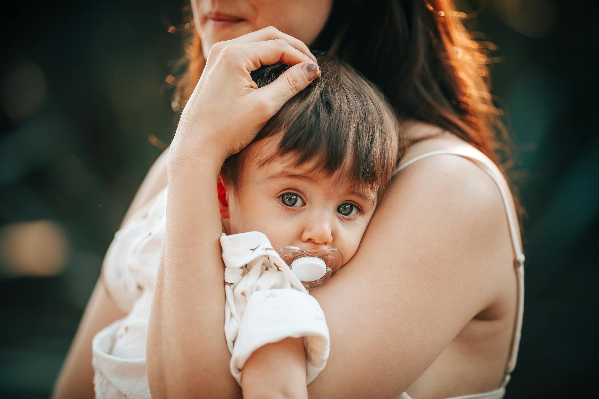 A woman holding a baby in her arms | Source: Pexels