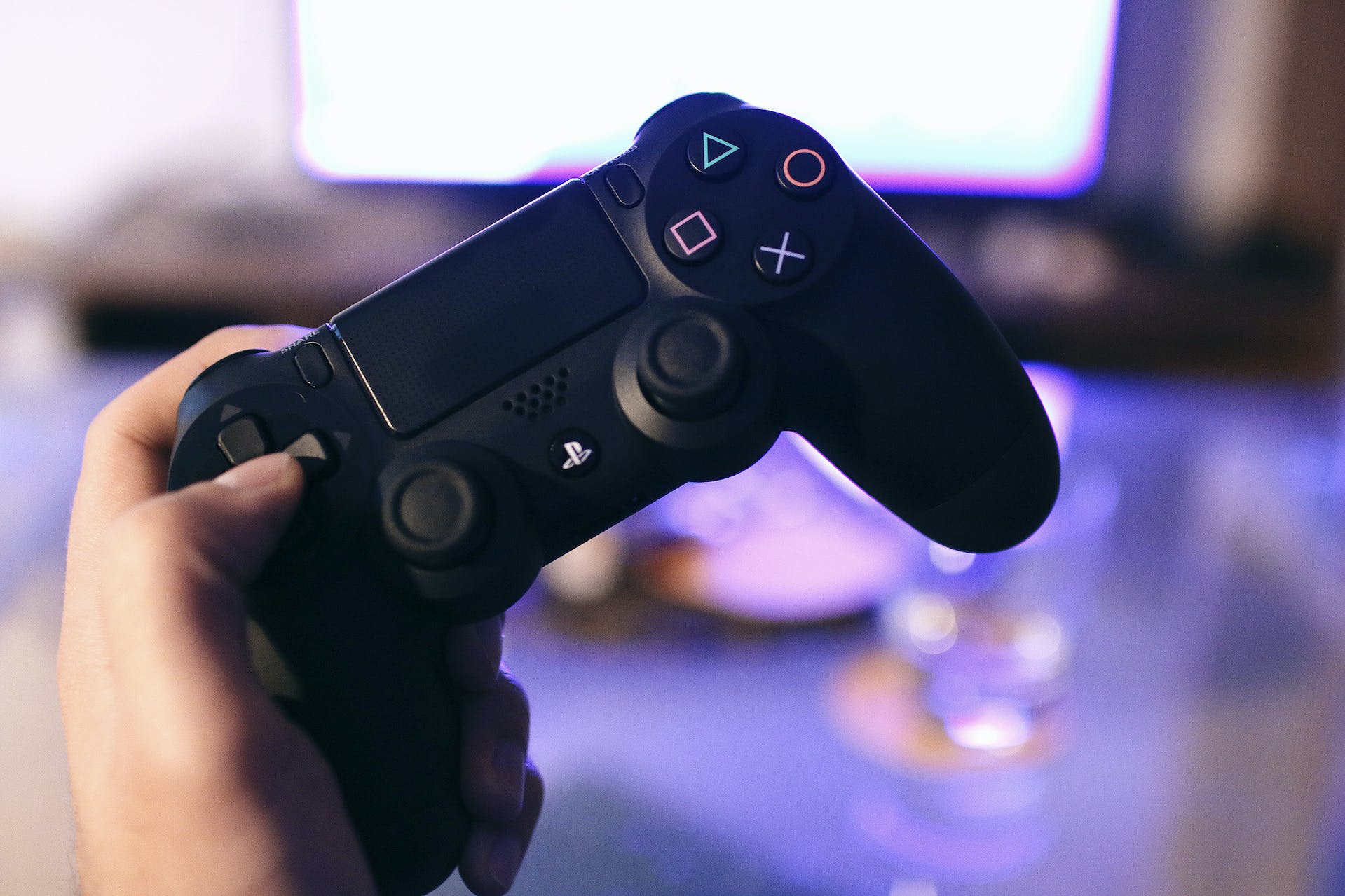 Person holding Playstation 4 | Source: Pexels