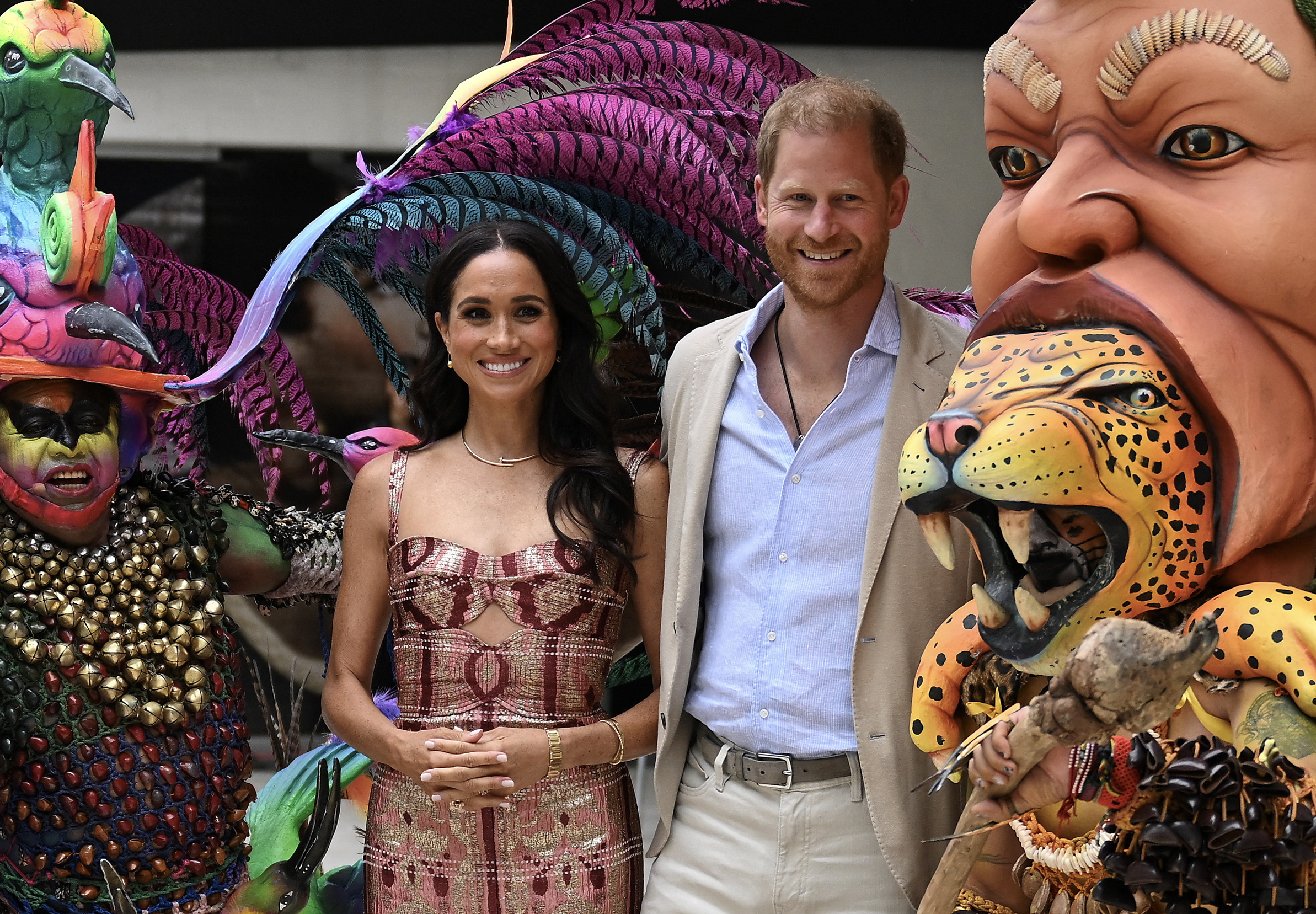 Meghan Markle and Prince Harry smile with the mascots at the Centro Nacional de las Artes Delia Zapata in Bogotá on August 15, 2024. | Source: Getty Images