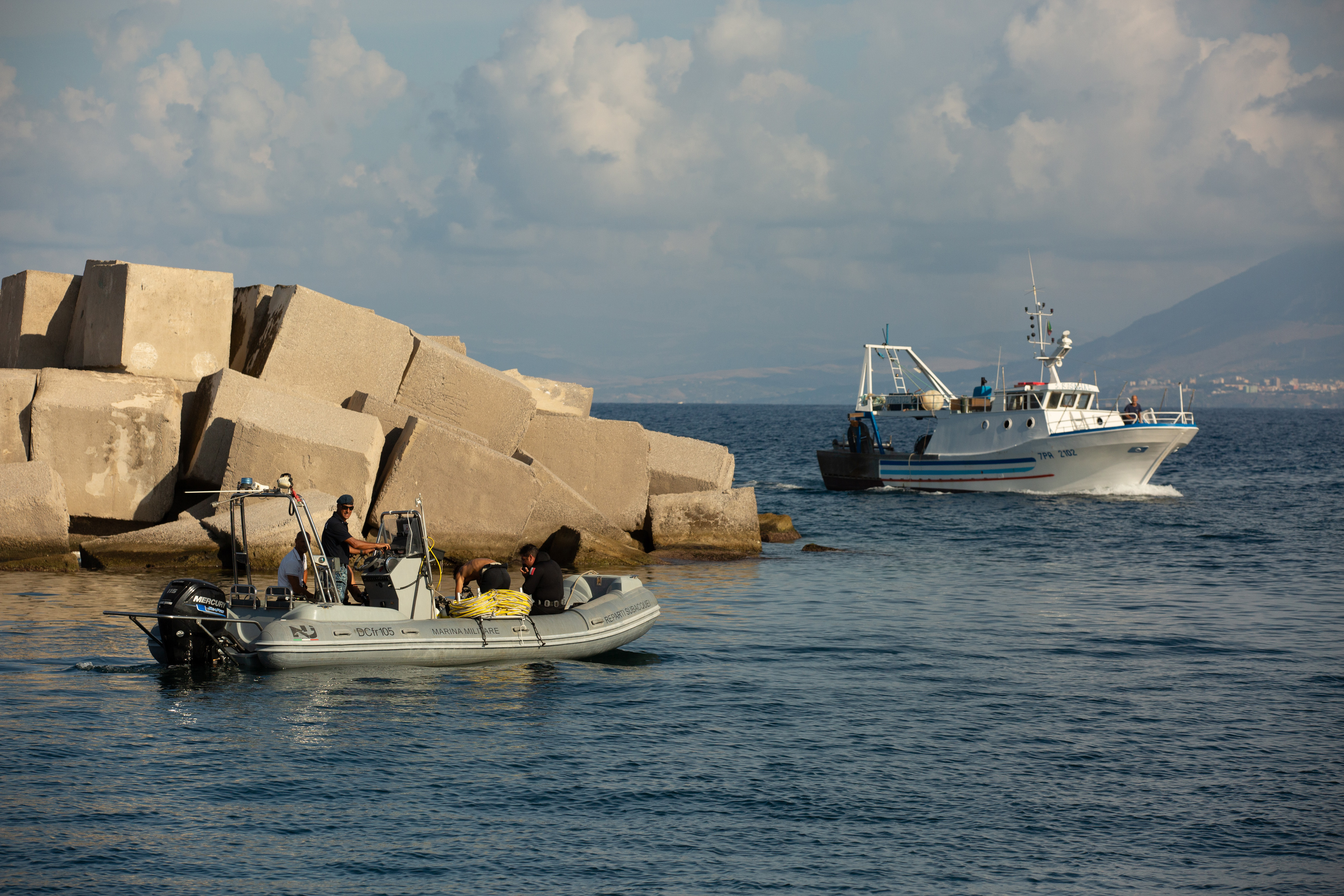 A fishing boat passing divers during search operations for Mike Lynchs luxury yacht Bayesian, off the coast of Porticello, Italy, on August 22, 2024. | Source: Getty Images