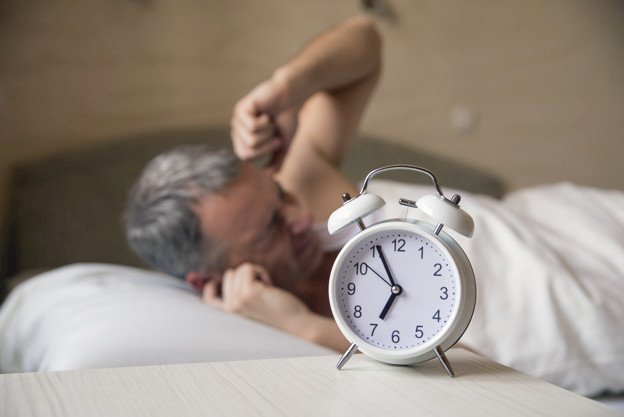 Alarm clock and a man | Source: Freepik
