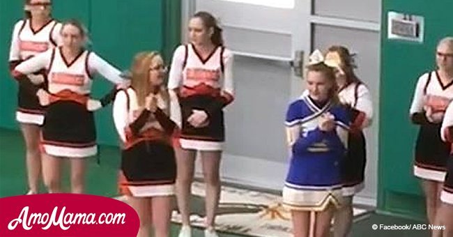 Cheerleaders surround girl from rival team. Luckily their actions got recorded so we can see it