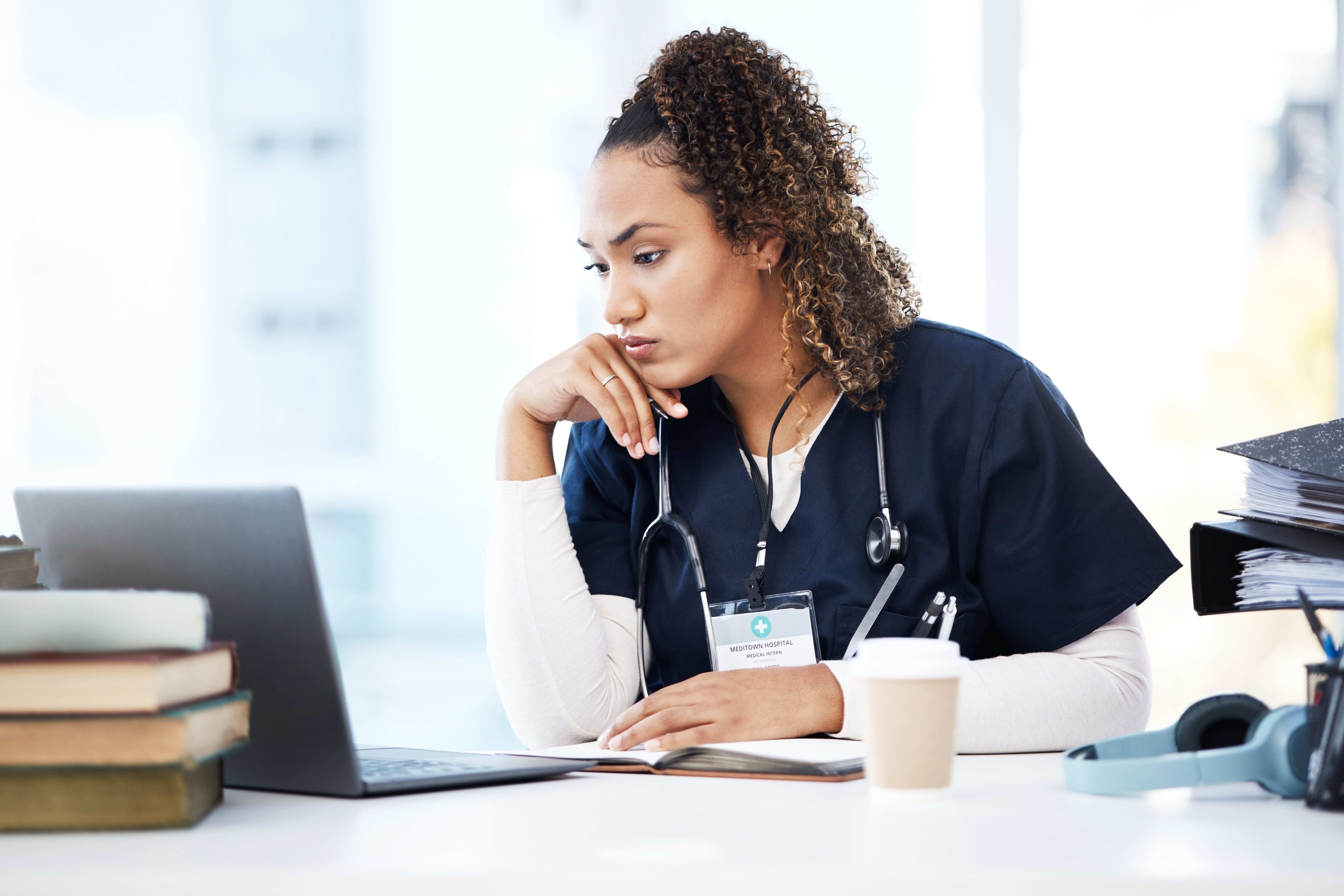 A nurse working on her computer | Source: Shutterstock