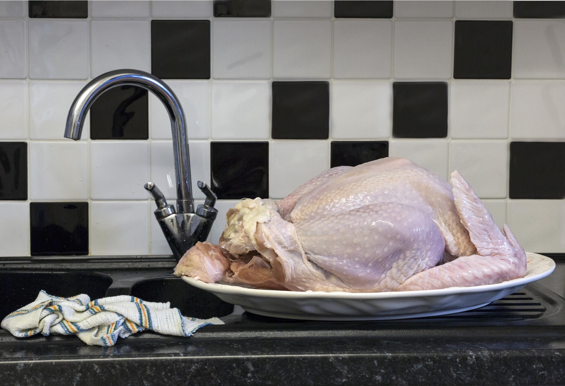 Raw poultry defrosting in the kitchen | Source: Getty Images