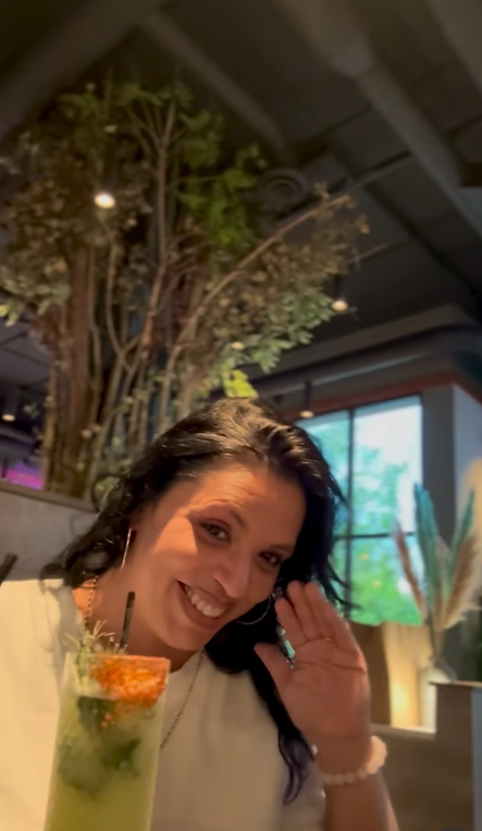 Margarita Aaron smiles and waves during a casual outing in a video | Source: Instagram/officialquintonaaron