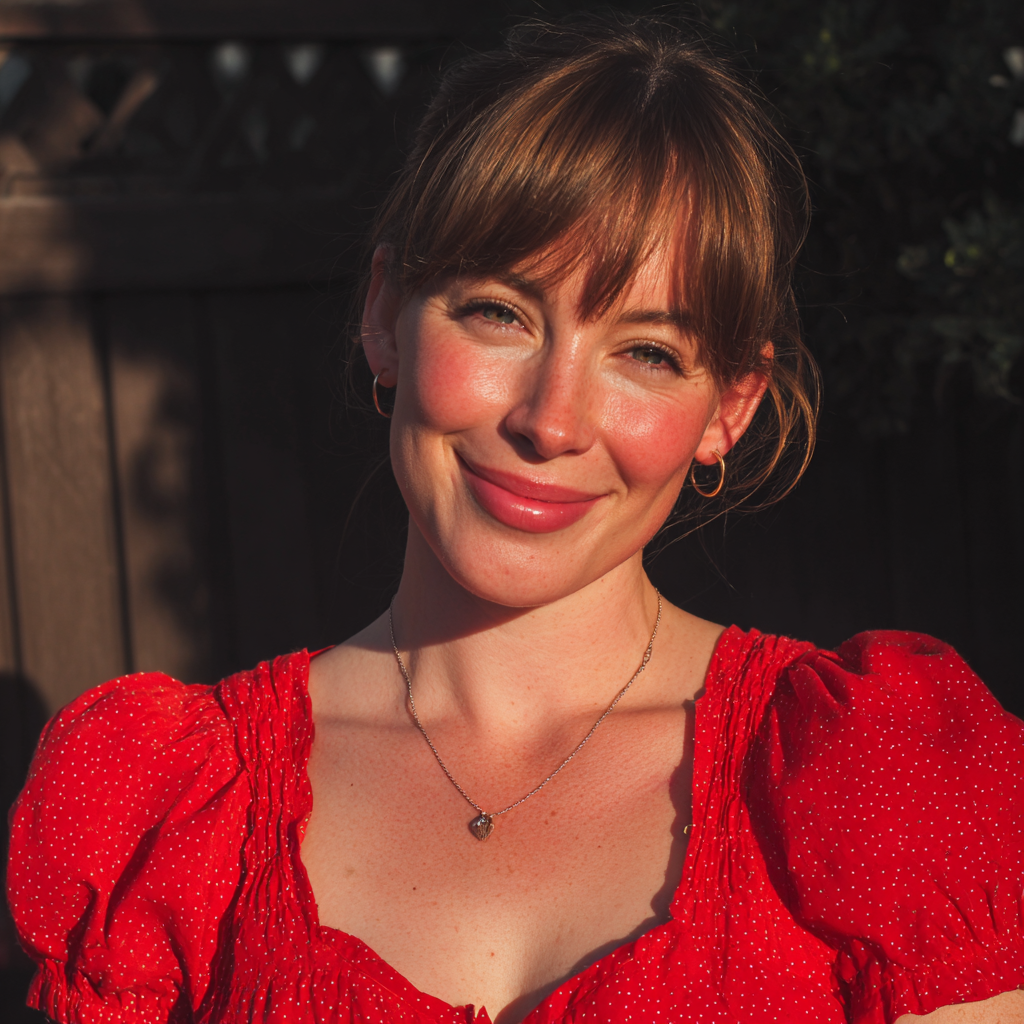 A smiling woman standing outside in a red dress | Source: Midjourney
