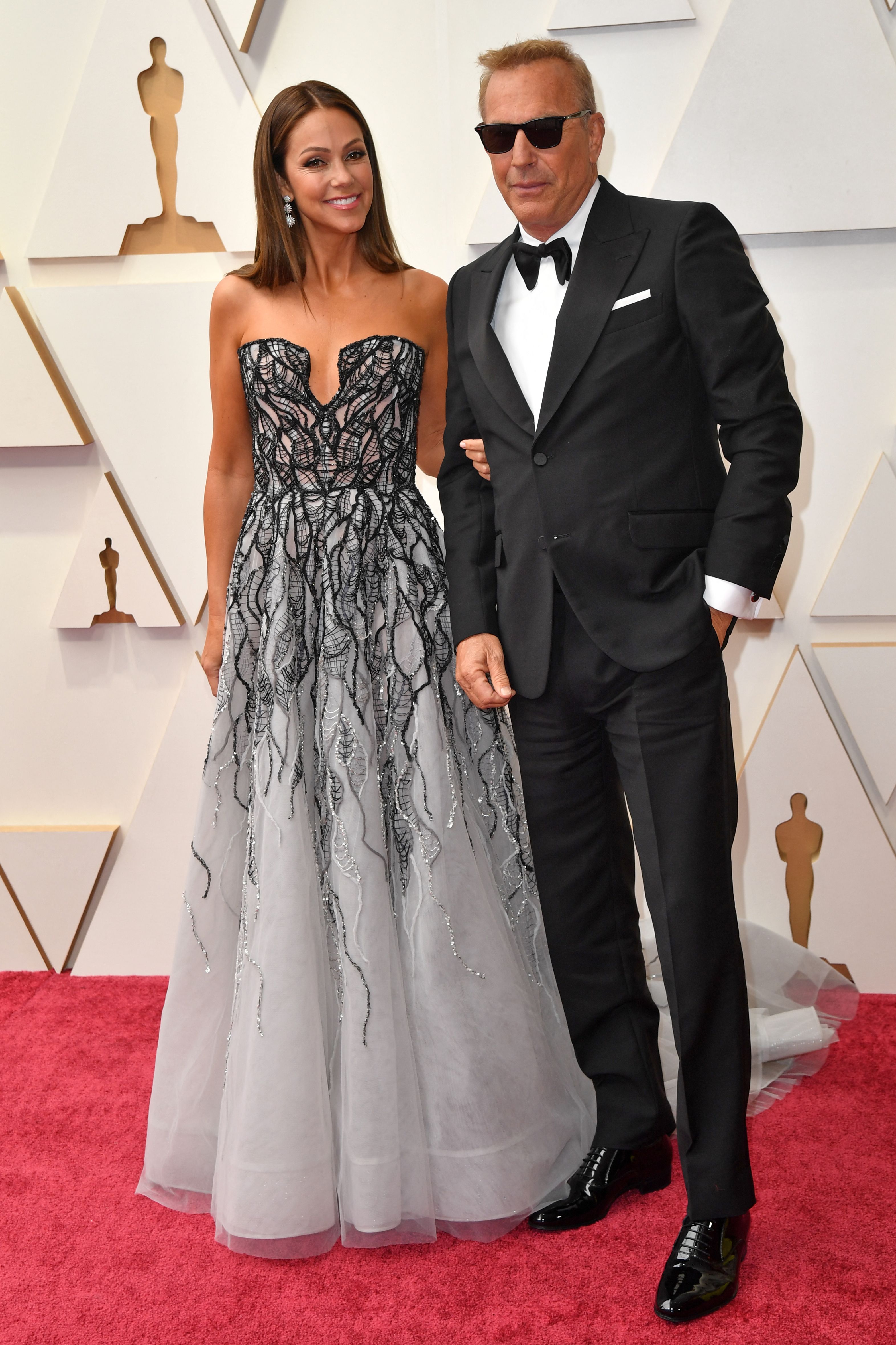 Kevin Costner and his wife Christine Baumgartner at the 94th Academy Awards at the Dolby Theatre in Hollywood, California on March 27, 2022 | Source: Getty Images