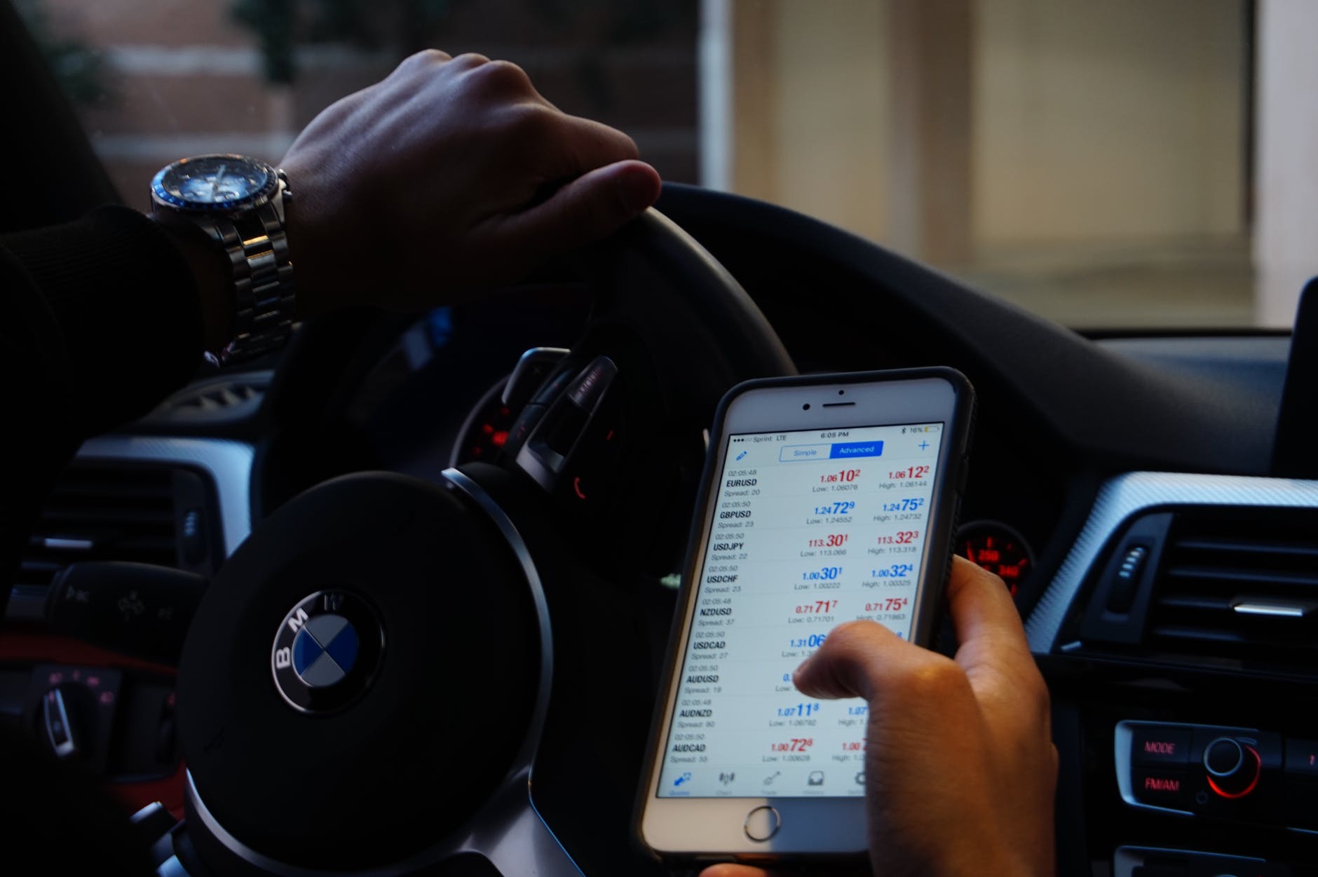 Driving while checking the phone | Source: Pexels