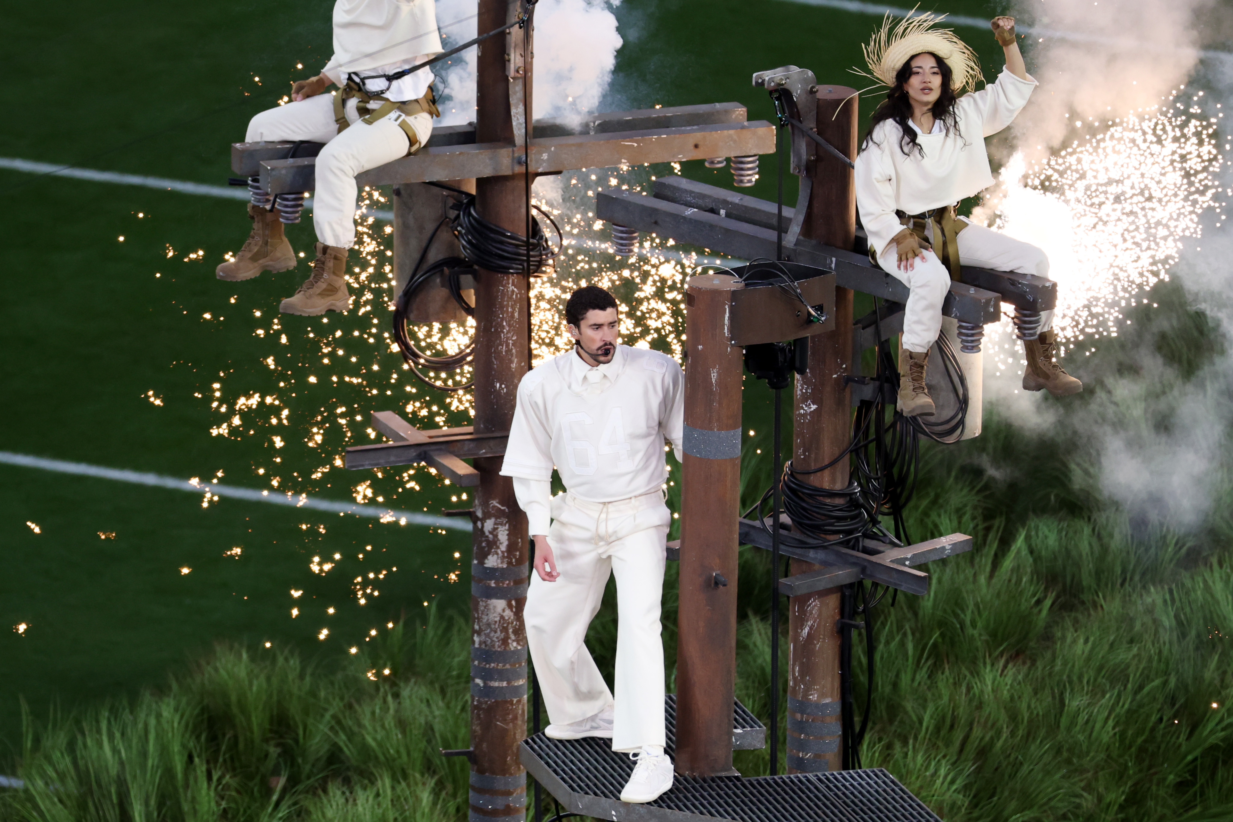 Bad Bunny stands on a metal platform between towering utility-pole-like structure during the Apple Music Super Bowl LX Halftime Show at Levi's Stadium on February 8, 2026 in California. | Source: Getty Images