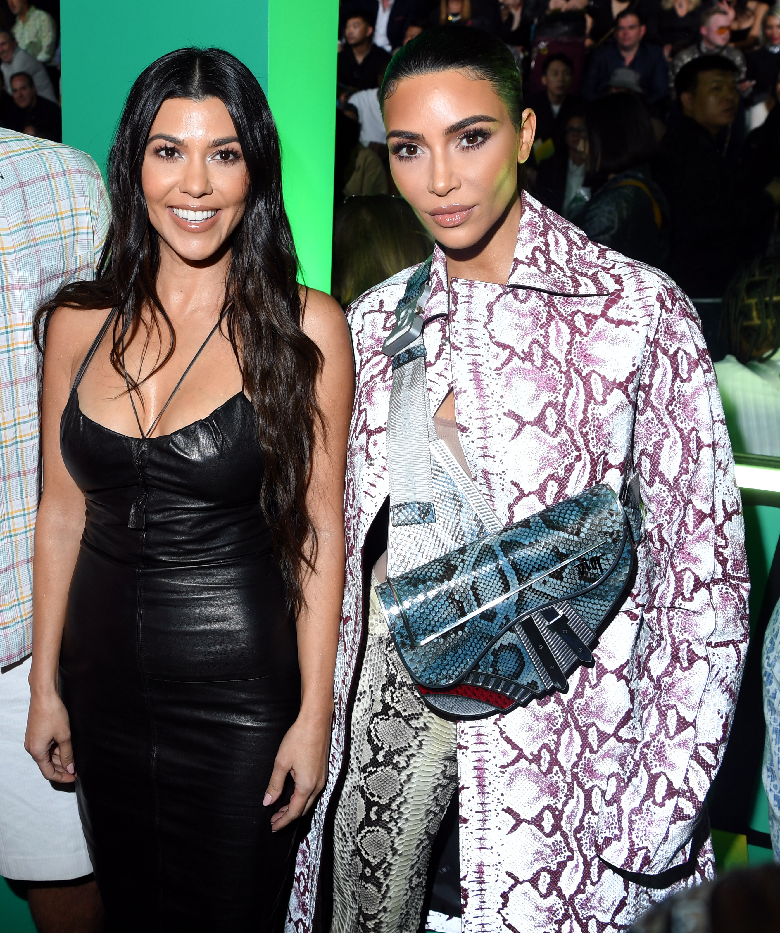 Kourtney and Kim Kardashian at the Dior Men's Show in Miami, Florida on December 3, 2019 | Source: Getty Images
