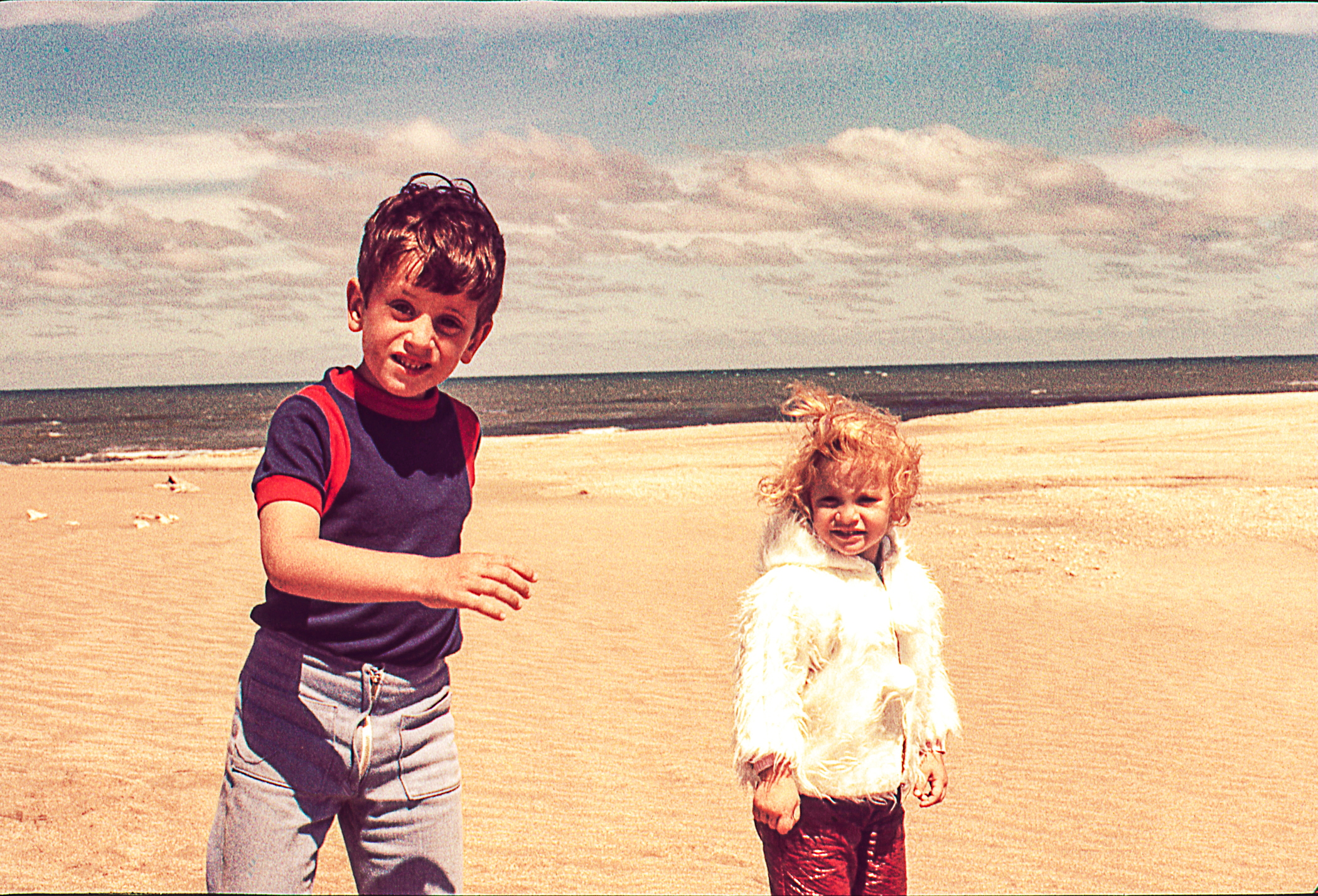 Brother and sister walking on the beach | Source: Getty Images