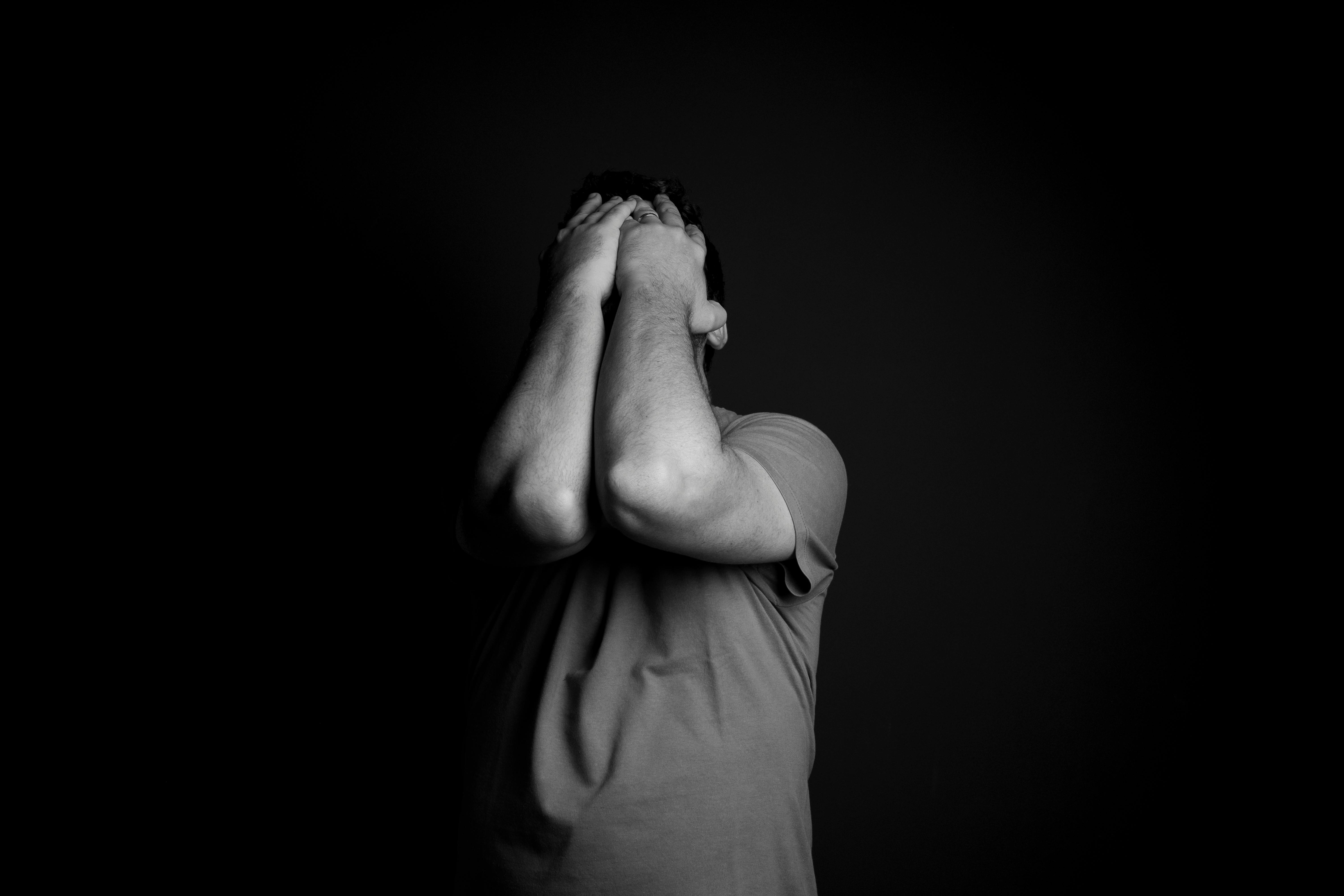 An emotional man covering his face with his hands | Source: Pexels