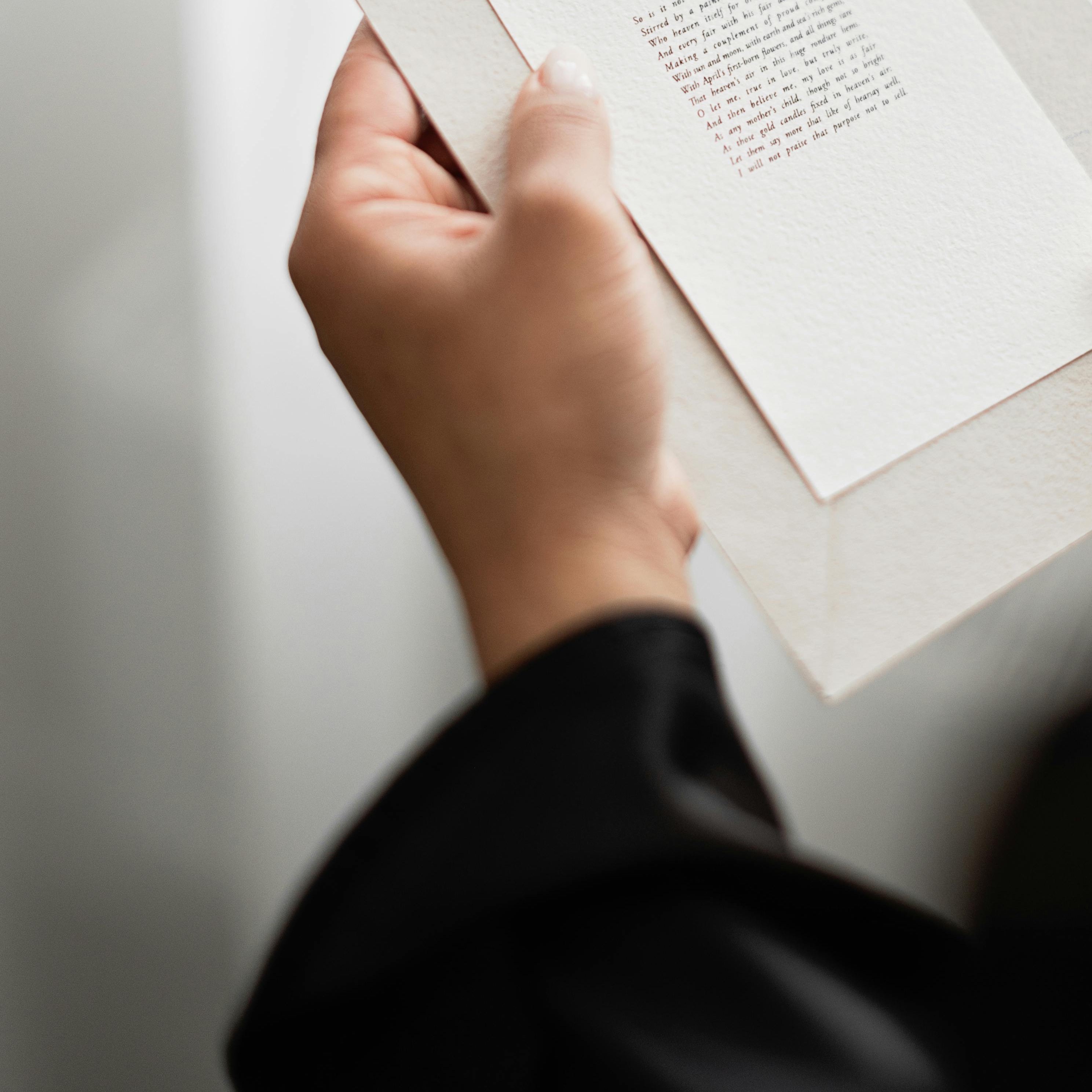 A hand holding a printed invitation | Source: Pexels