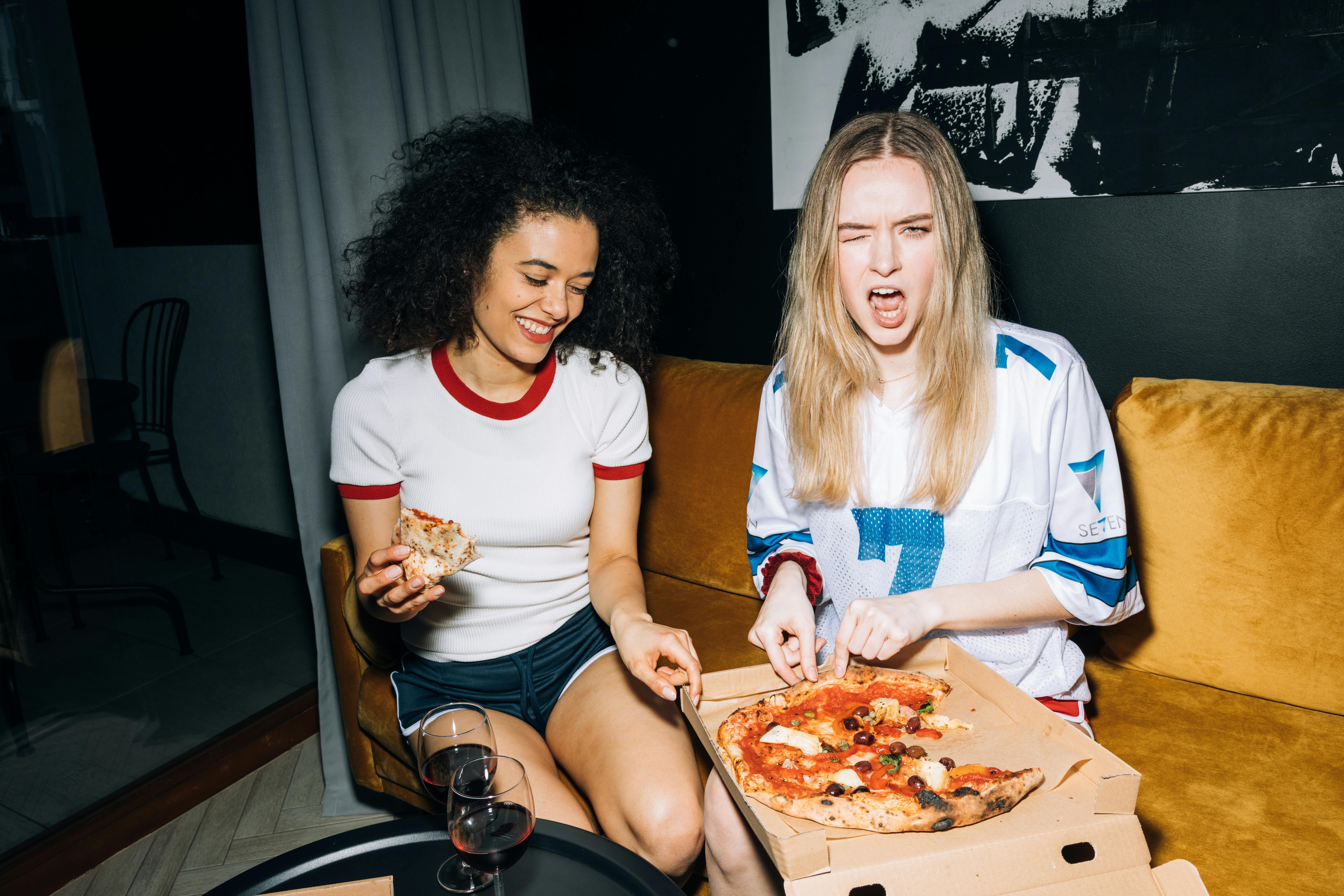 A woman winking and having a great time with her friend | Source: Pexels