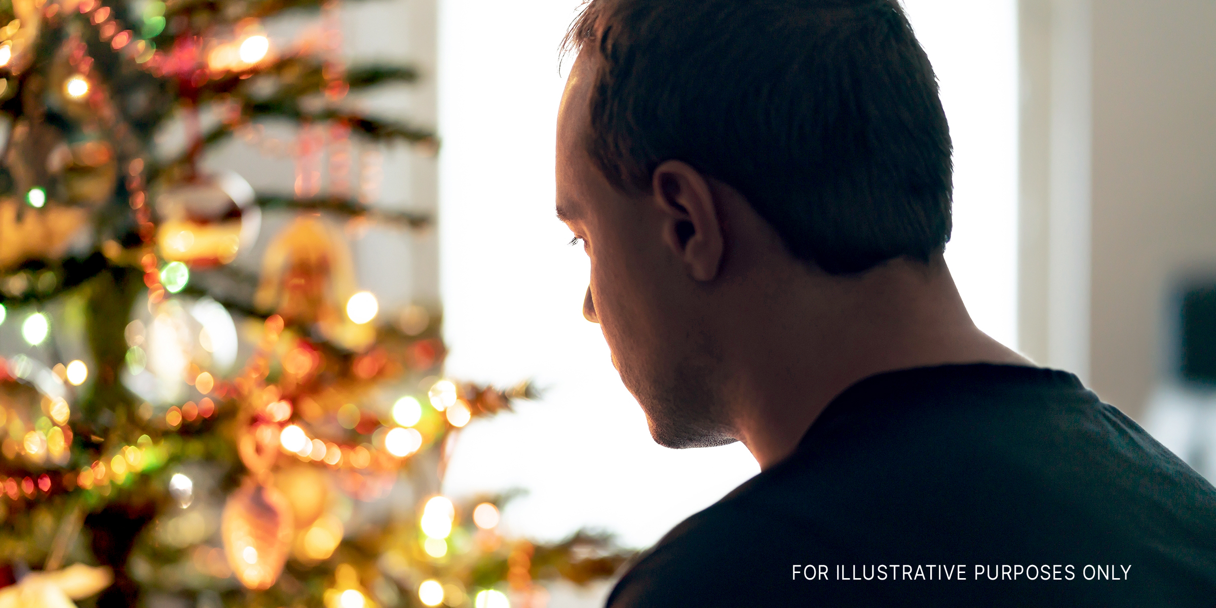 Man staring at a Christmas tree | Source: Shutterstock