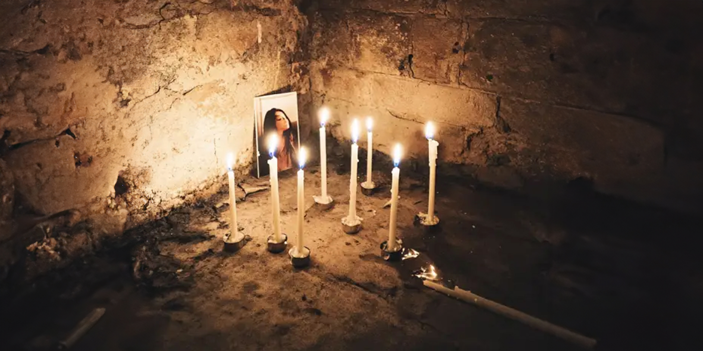 Woman's photo surrounded by candles | Source: Midjourney