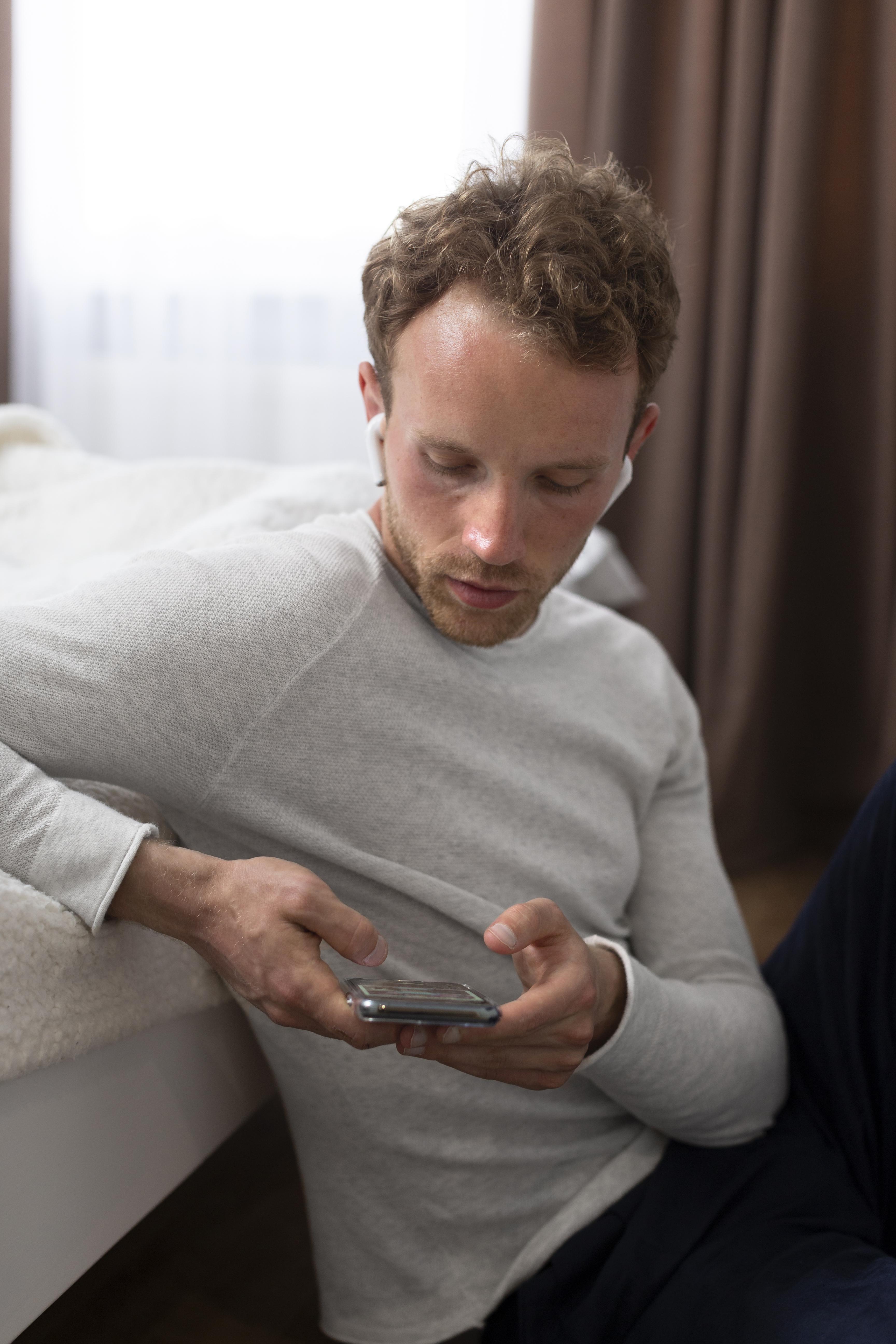 A man typing on his phone | Source: Freepik