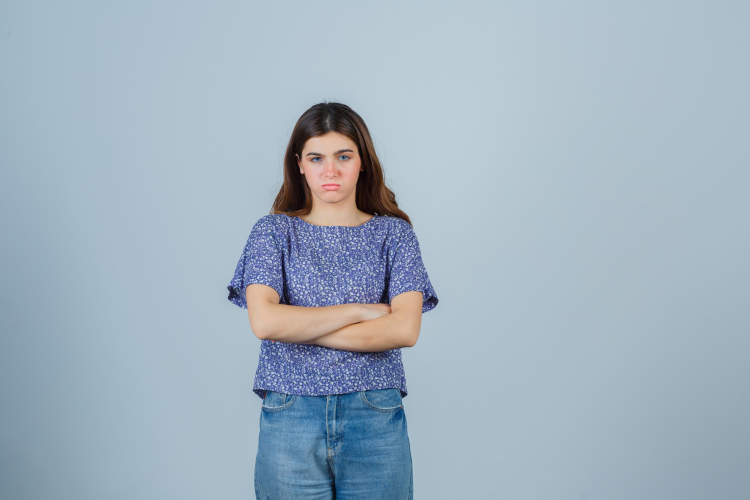 An annoyed woman with her arms crossed | Source: Freepik