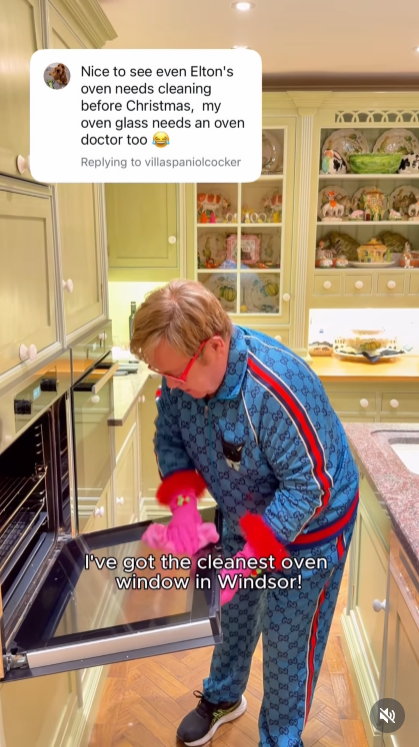 As "Step Into Christmas" blares from inside the oven, John launches into his own off-key serenade, scrubbing and singing with gusto before triumphantly declaring he's got "the cleanest oven window in Windsor!" | Source: Instagram/eltonjohn