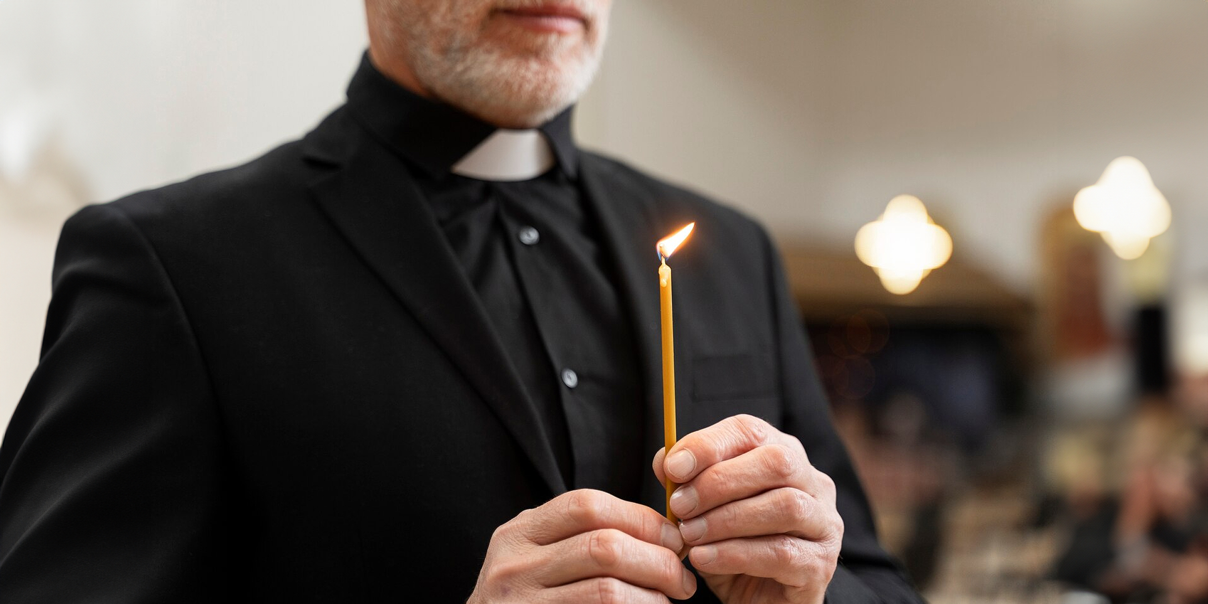 A priest holding a candle | Source: Freepik