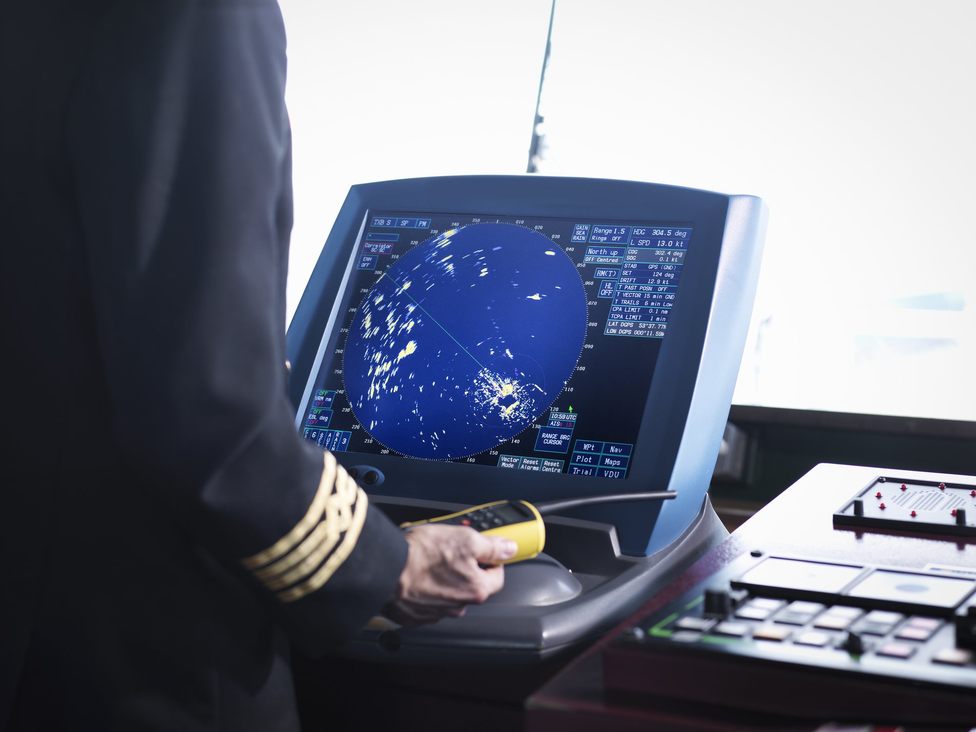 Ships captain working on bridge with radar screen, close up | Photo: Getty Images