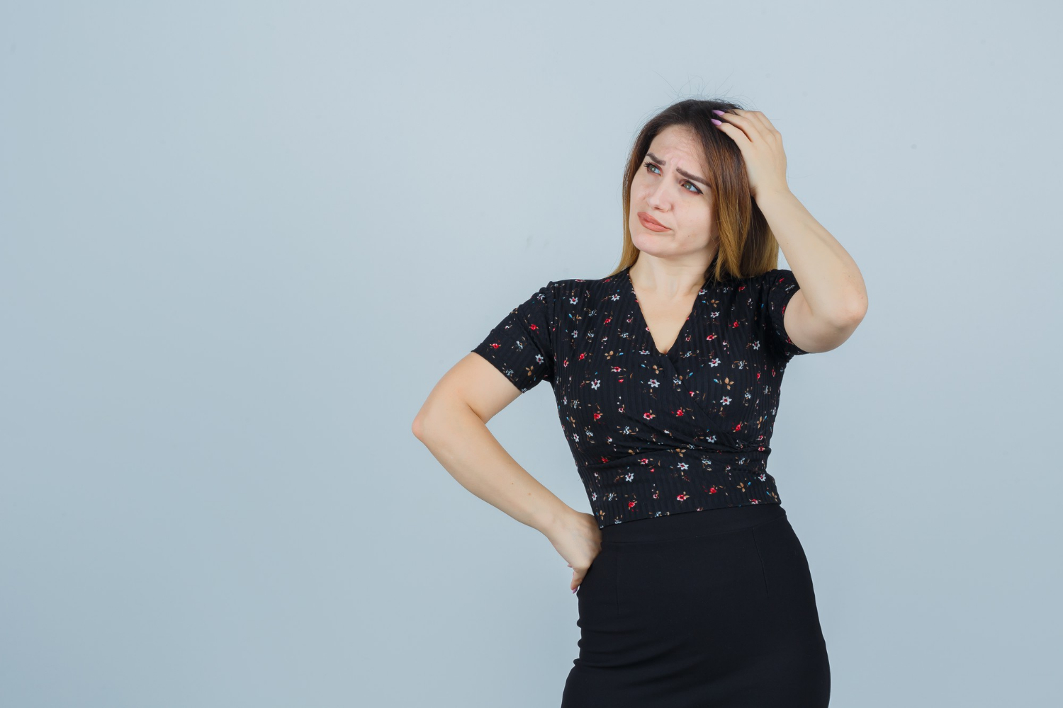 An expressive woman holding her head | Source: Freepik