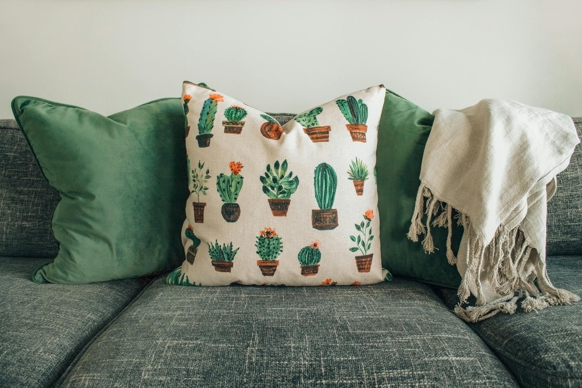White and green pillows on a couch | Source: Pexels