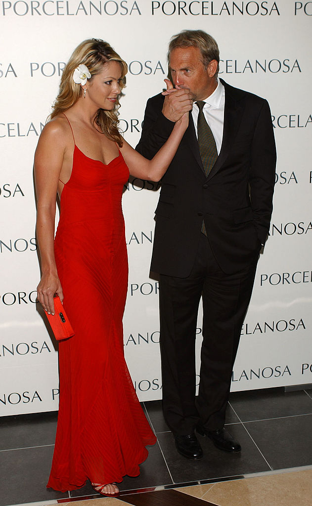 Christine Baumgartner turned heads in a strapless black gown beside Kevin Costner, who looked sharp in a charcoal suit, as the couple attended the glitzy Porcelanosa store opening in Madrid. They stayed close on the carpet, flashing warm smiles and undeniable chemistry.