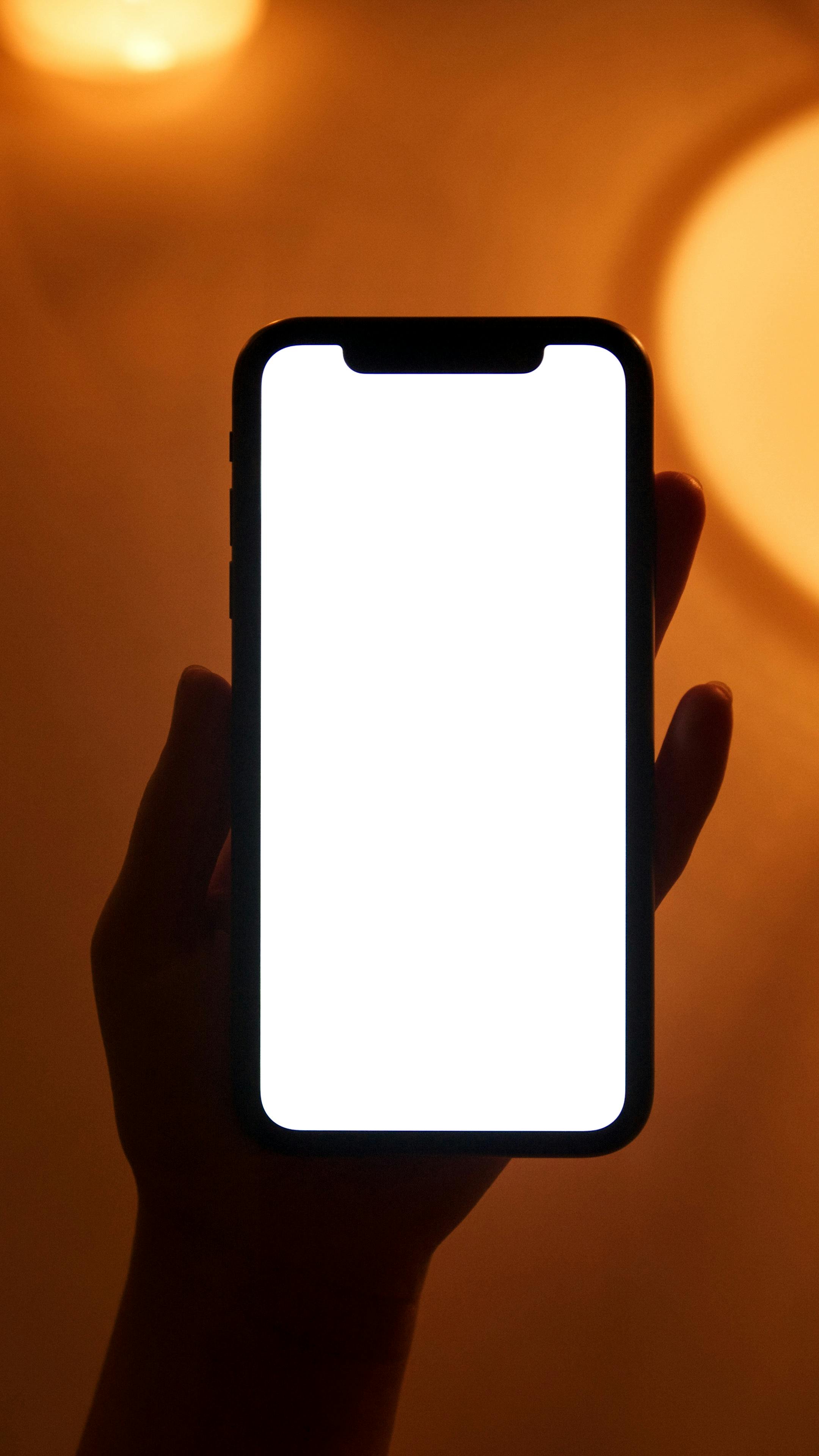 A hand holding up a phone | Source: Pexels