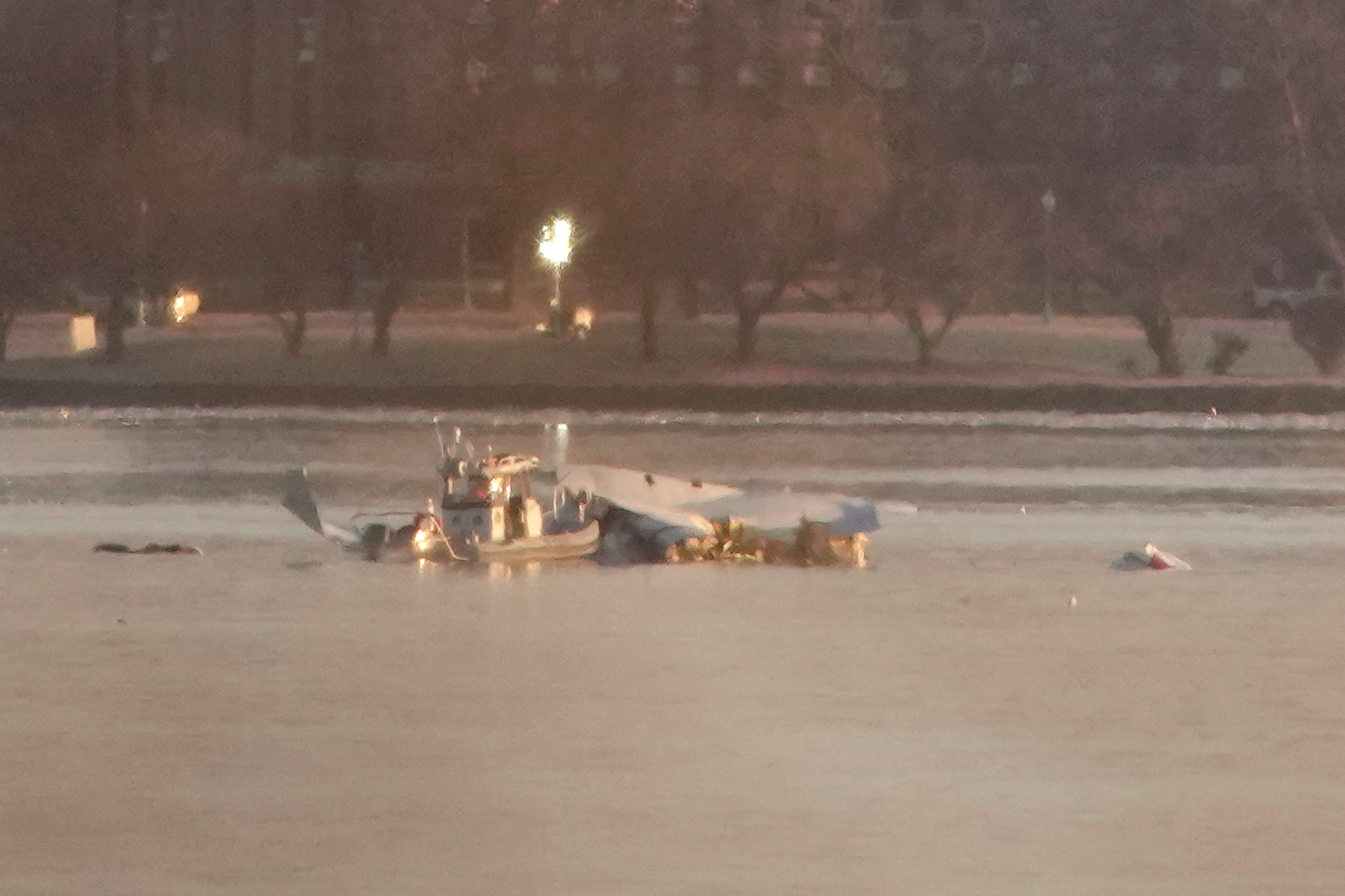 Emergency response units searching the crash site after the collision between an American Airlines plane and an Army helicopter in Washington, D.C., on January 30, 2025. | Source: Getty Images