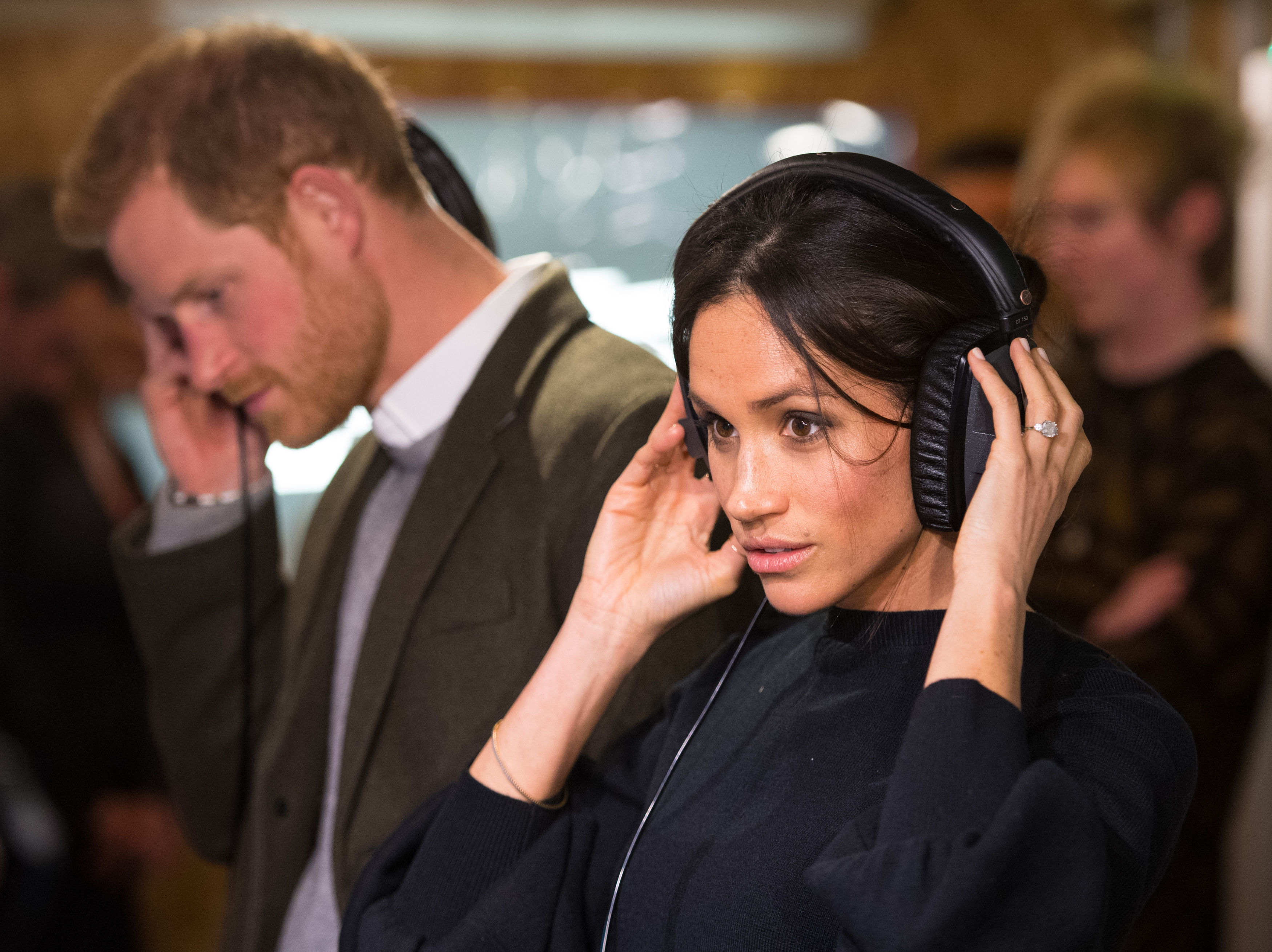 Prince Harry and Meghan Markle listen to a broadcast through headphones at Reprezent 107.3FM in Pop Brixton on January 9, 2018 in London, England. | Source: Getty Images
