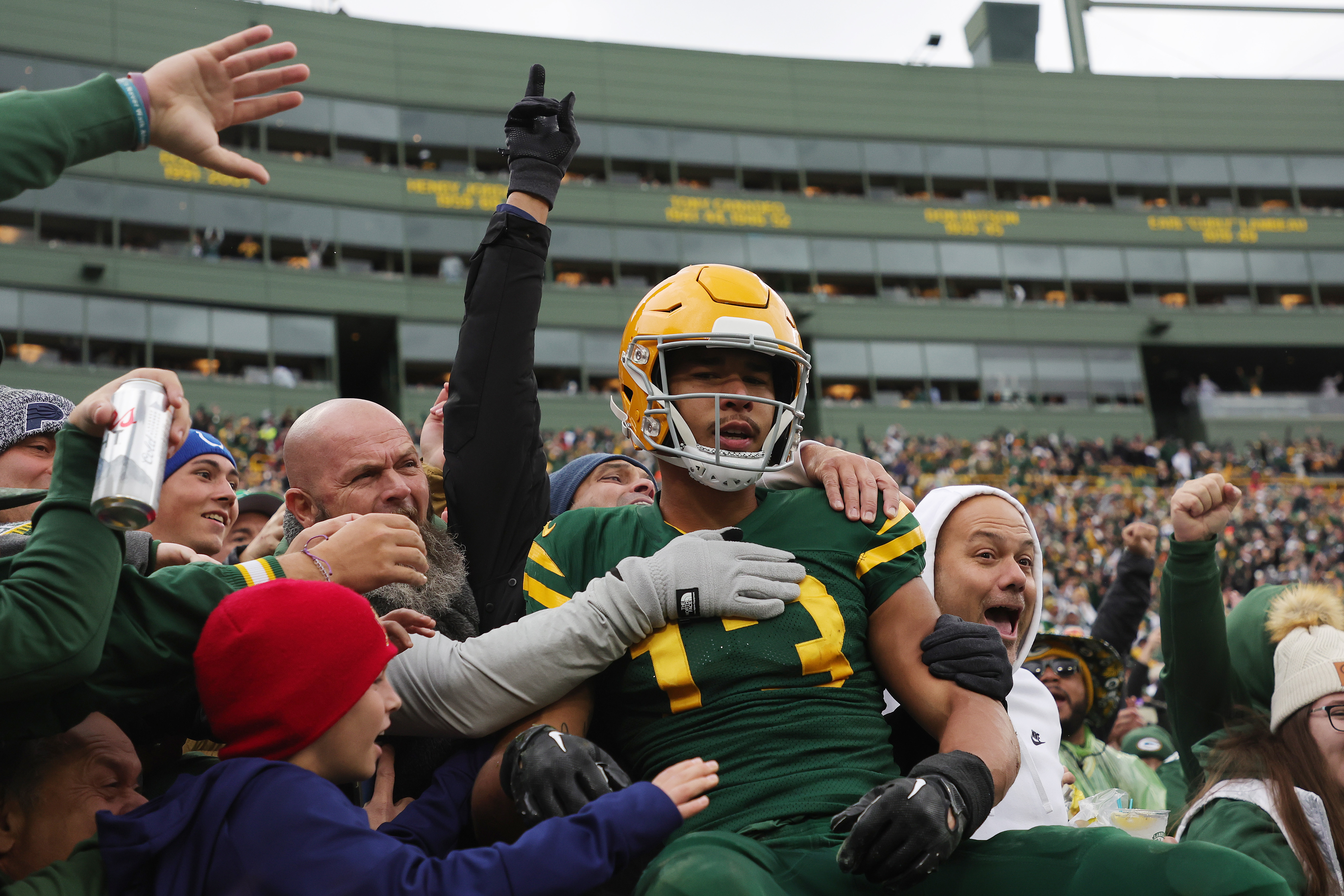 Green Bay Packers celebrate with the crowd after scoring a touchdown against the New York Jets at Lambeau Field on October 16, 2022 | Source: Getty Images