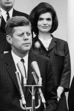 President John F. Kennedy speaks during a press conference at the White House as First Lady Jackie Kennedy looks on April 9, 1963 | Source: Getty Images