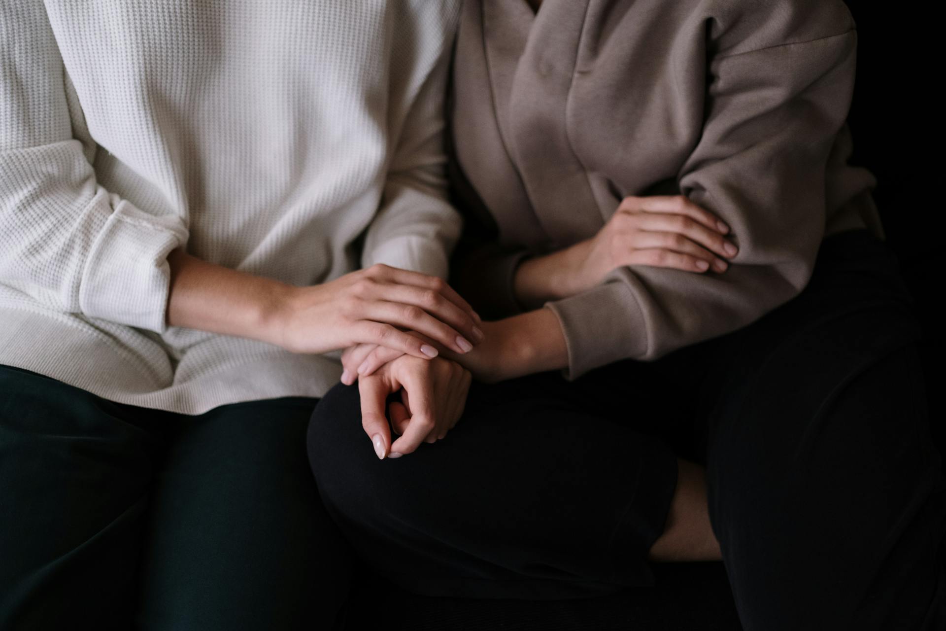 Close-up shot of two women holding hands for support | Source: Pexels