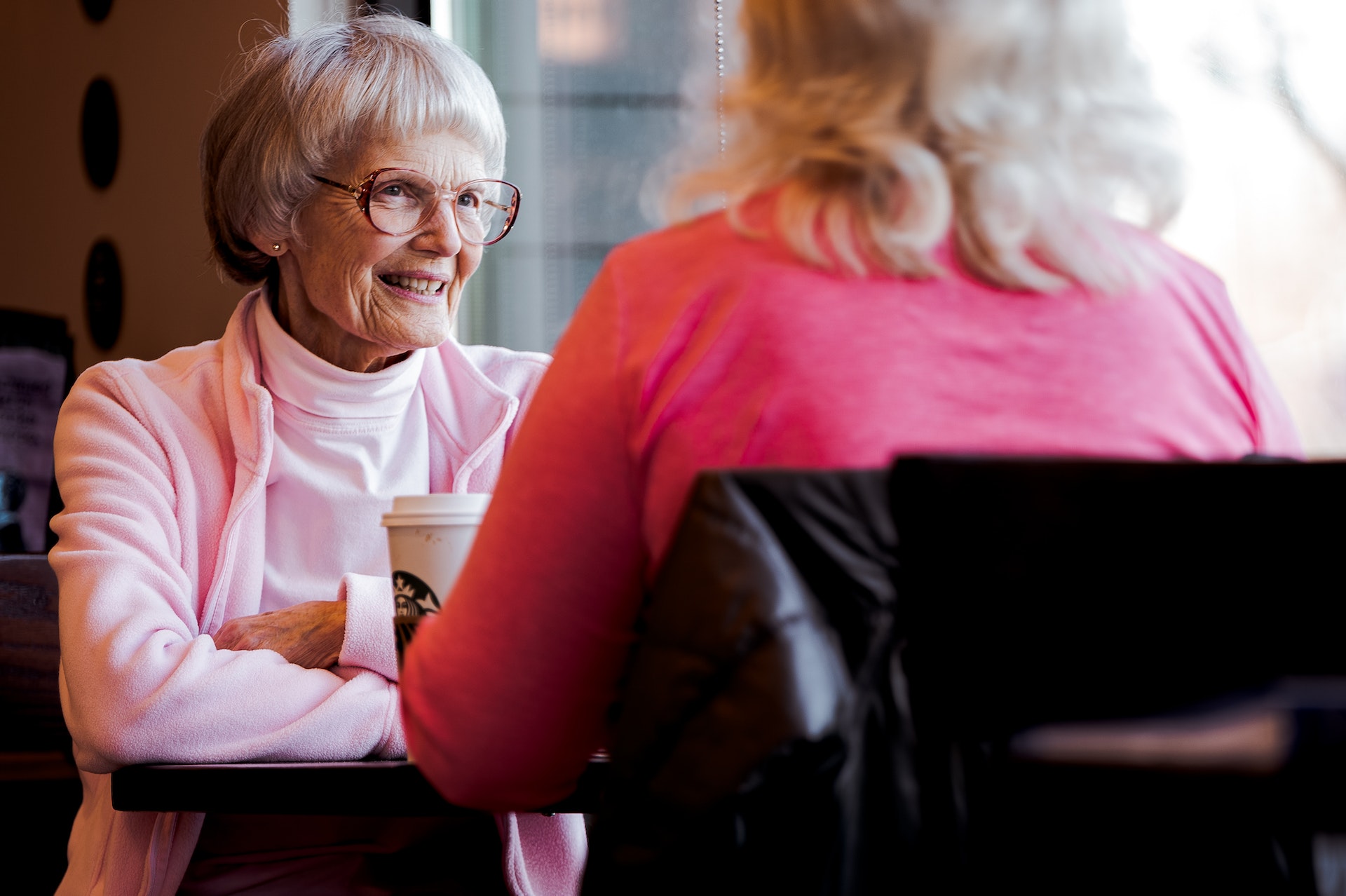 A senior lady talking to another woman in a cafe | Source: Pexels
