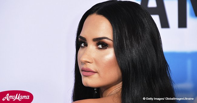 Demi Lovato leaves nothing to imagination as she poses in black low cut swimsuit