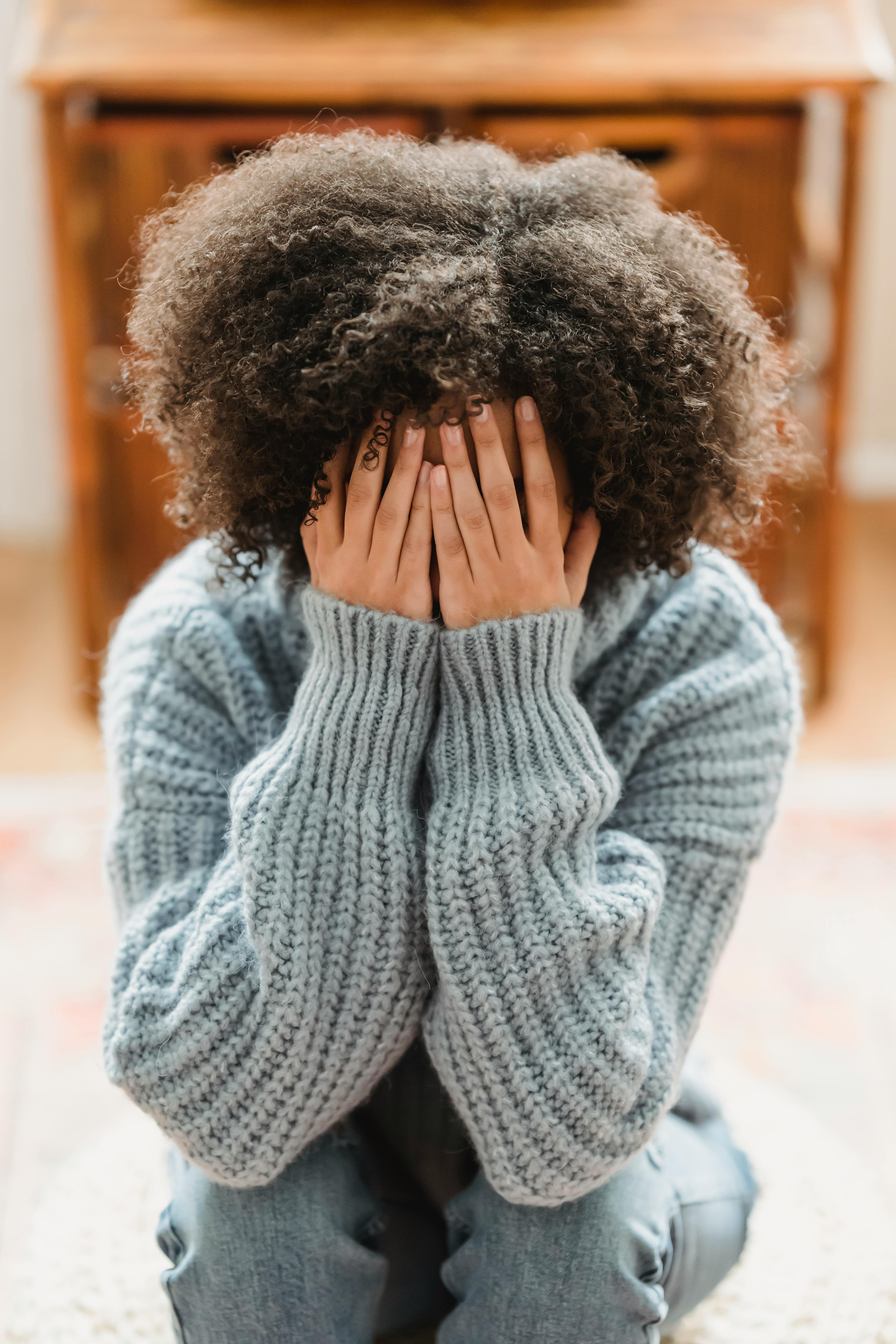An upset woman covering her face | Source: Pexels