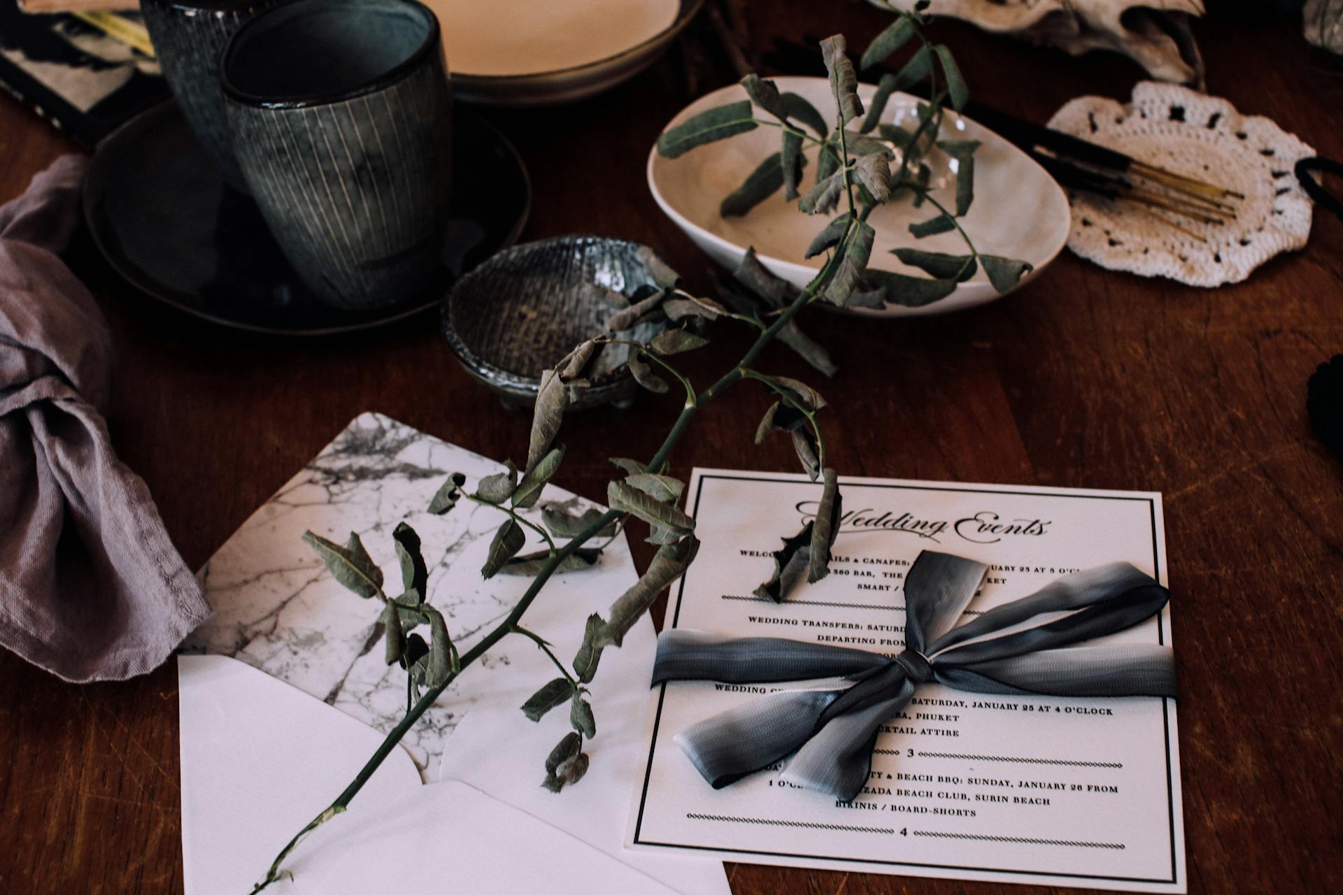 A wedding invitation on a table with utensils and decorations | Source: Pexels