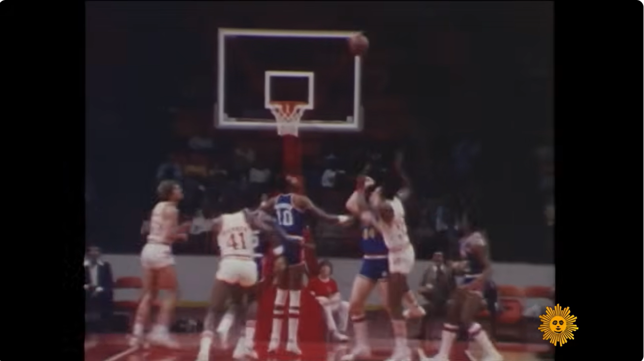 Players battle beneath the basket during a vintage Atlanta Hawks game, one of the professional sports franchises acquired by media mogul Ted Turner as he expanded his growing entertainment empire. | Source: YouTube/CBS Sunday Morning