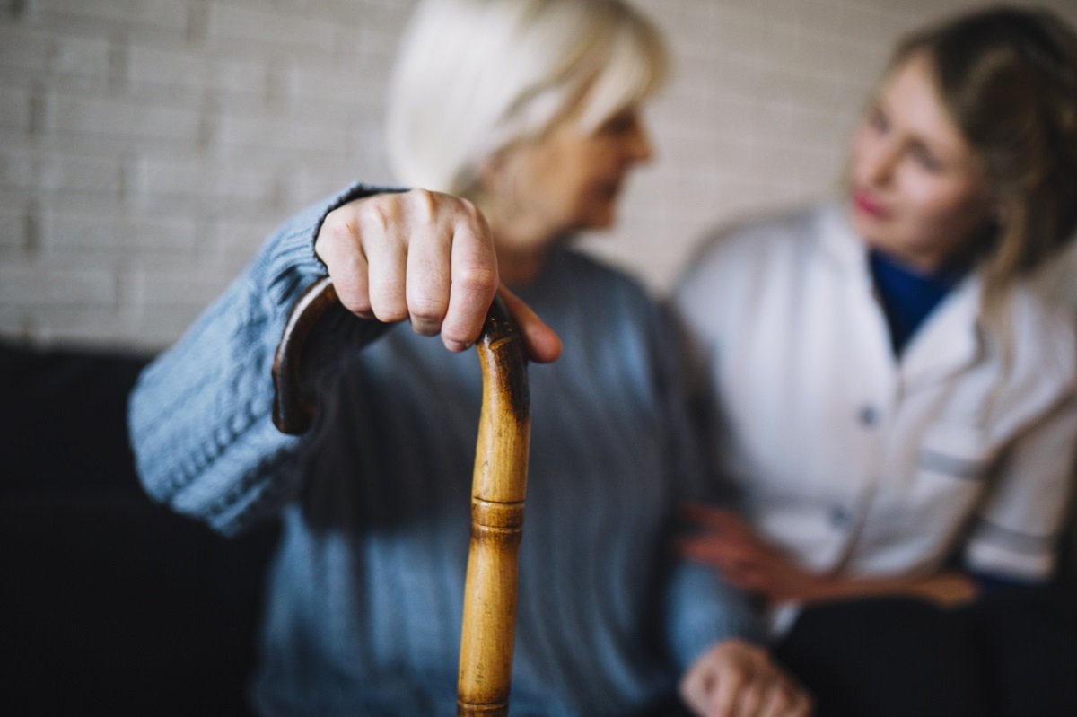 Enfermera conversa con anciana con bastón. | Foto: Freepik