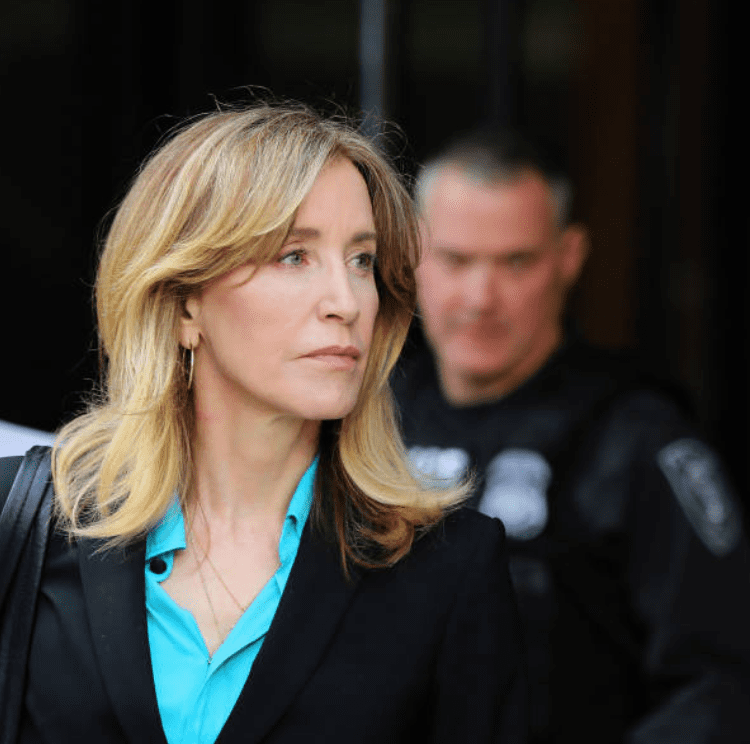 For her role in the college admissions scandal, Felicity Huffman is escorted by police and legal team she leaves the John Joseph Moakley United States Courthouse, on April 3, 2019, Boston | Source: Pat Greenhouse/The Boston Globe via Getty Images