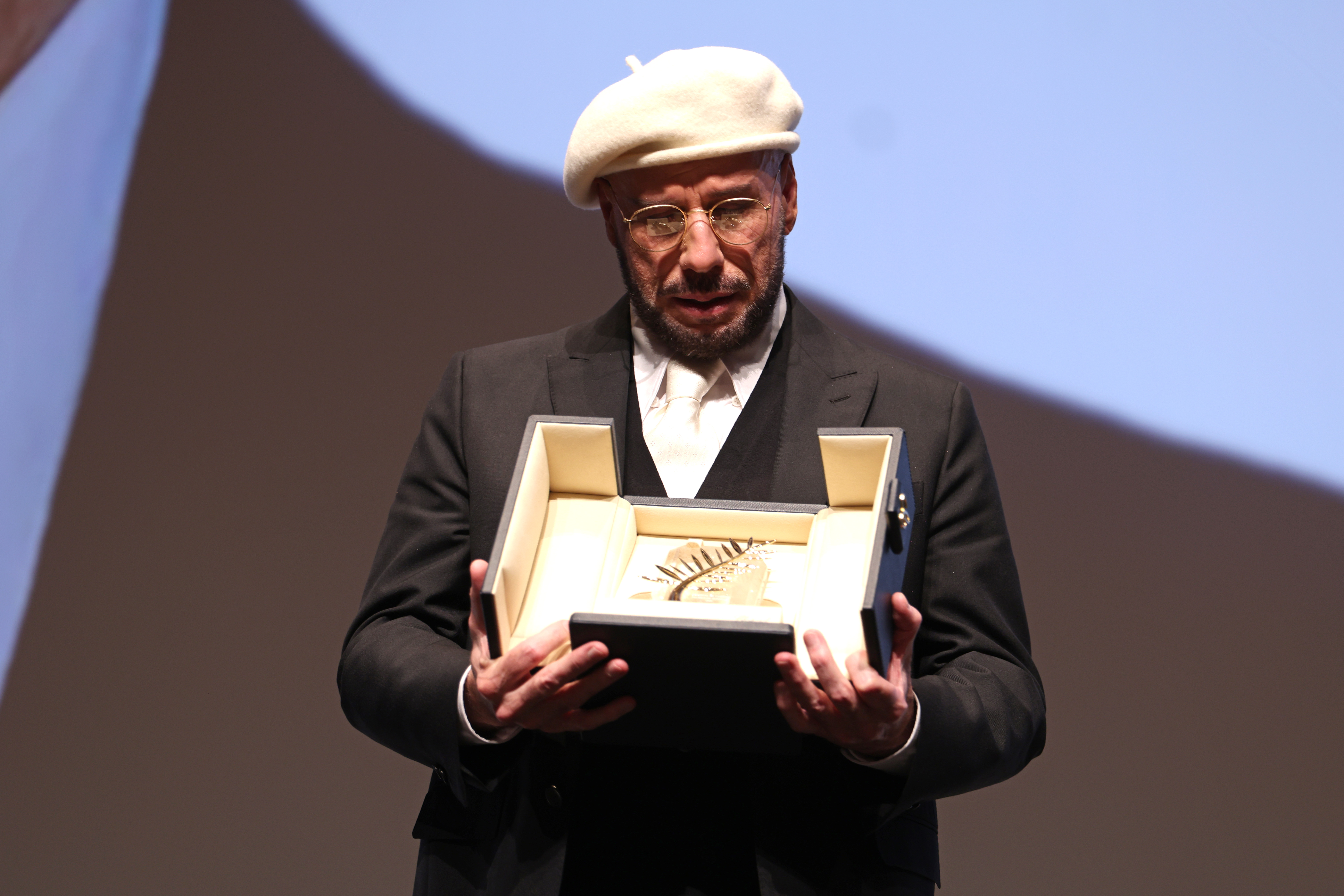 John Travolta accepts the Honorary Palme Award onstage during the annual Cannes Film Festival at Plage Macé on May 15, 2026, in Cannes, France | Source: Getty Images