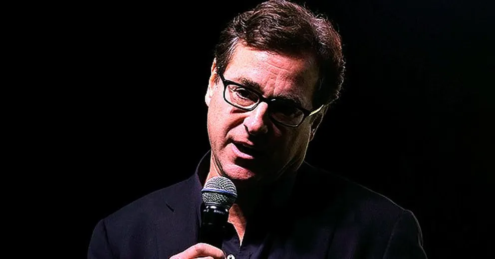 Stand-up comedian Bob Saget speaks on stage during an event. | Source: Getty Images