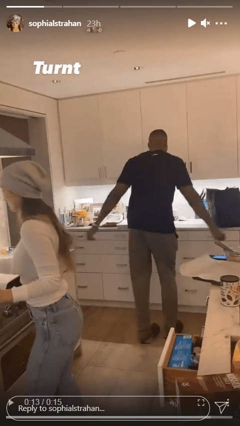 A screenshot of Michael Strahan and his girlfriend Kayla Quick having a fun time in the kitchen cooking. | Photo: Instagram/Sophianlstrahan